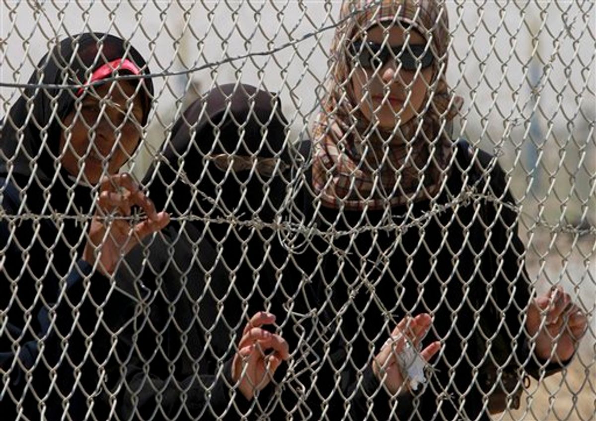 Palestinian women wait to cross to Egypt at the Rafah border crossing, southern Gaza Strip, Tuesday, June 21, 2011. (AP Photo /Hatem Moussa) (AP)