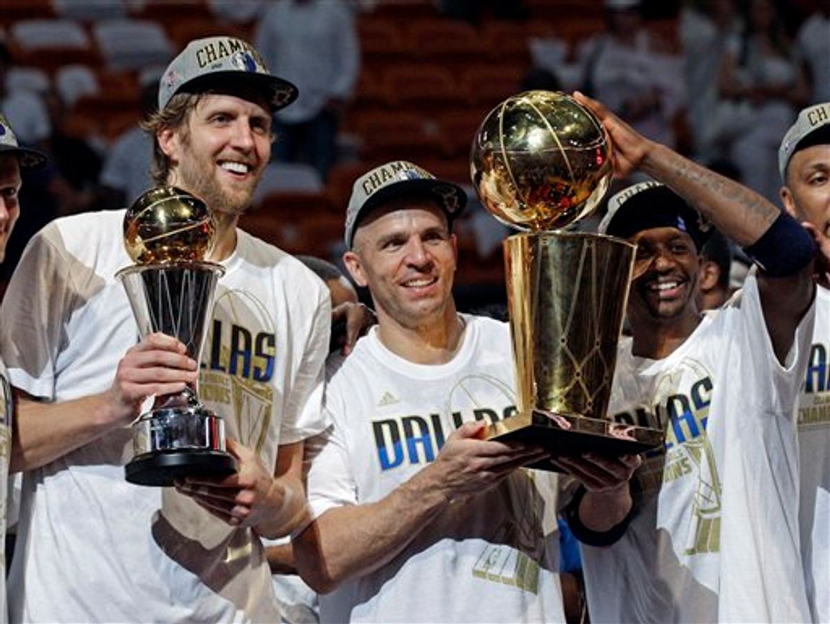 Dallas Mavericks' Dirk Nowitzki, Jason Kidd and Jason Terry hold up their trophies after Game 6 of the NBA Finals basketball game against the Miami Heat Sunday, June 12, 2011, in Miami. The Mavericks won 105-95 to win the series. (AP Photo/David J. Phillip)  (AP)