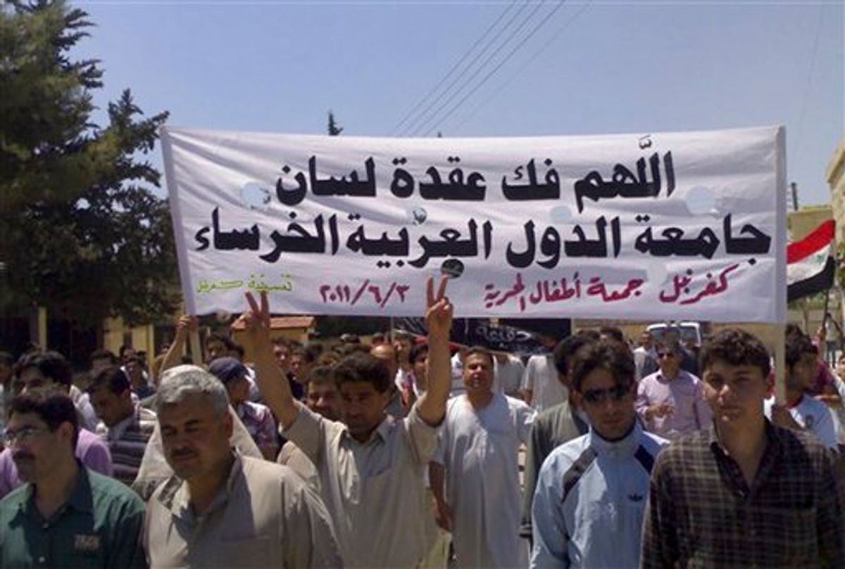 In this citizen journalism image made on a mobile phone and provided by Shaam News Network, Syrian protesters hold an Arabic banner read:"May God help break the silence of the Arab League," as they march during a protest at the village of Kfar-Nebel, in the northen province of Edleb, Syria, on Friday June 3, 2011. Syrian troops pounded a central town with artillery and heavy machinegun fire Friday, killing at least two people in the latest onslaught as authorities cut off Internet service in several regions in an apparent move to prevent the uploading of videos of anti-regime demonstrations, activists said. (AP Photo/Shaam News Network) EDITORIAL USE ONLY, NO SALES, THE ASSOCIATED PRESS IS UNABLE TO INDEPENDENTLY VERIFY THE AUTHENTICITY, CONTENT, LOCATION OR DATE OF THIS HANDOUT PHOTO (AP)