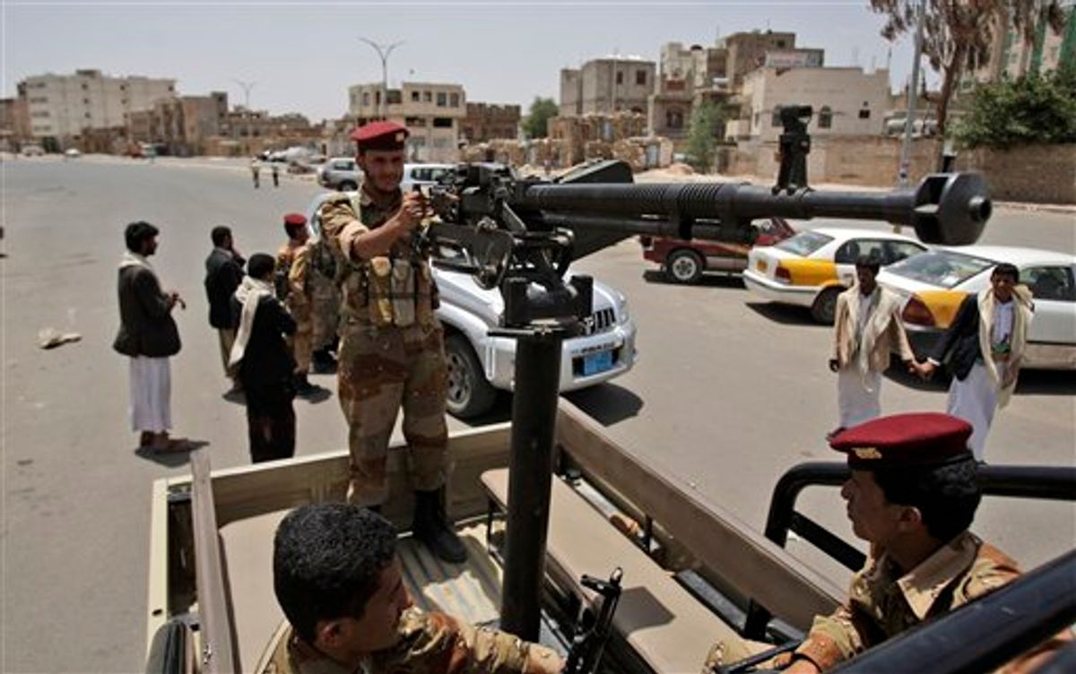 Yemeni army soldiers patrol in a vehicle an area in Sanaa, Yemen, Thursday, June 9, 2011. Government troops trying to recapture areas held by Islamic militants have killed 12 suspected al-Qaida members in the troubled southern province of Abyan, the Defense Ministry said Thursday. (AP Photo/Hani Mohammed) (AP)