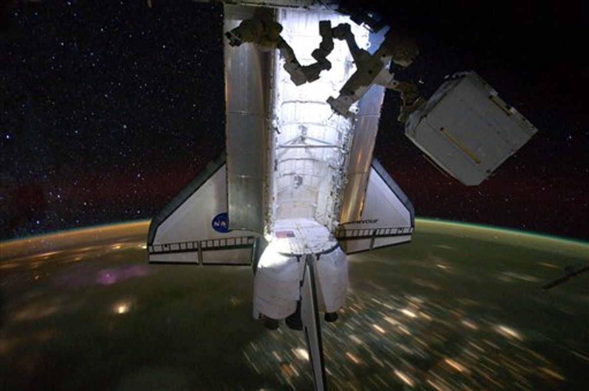A photo released by Nasa shows the Endeavour with a backdrop of a night time view of the Earth and the starry sky, while docked at the International Space Station on Saturday May 28, 2011. The STS-134 astronauts left the station the next day on May 29, after delivering the Alpha Magnetic Spectrometer and performing four spacewalks during Endeavour's final mission.  (AP Photo/NASA)   (AP)