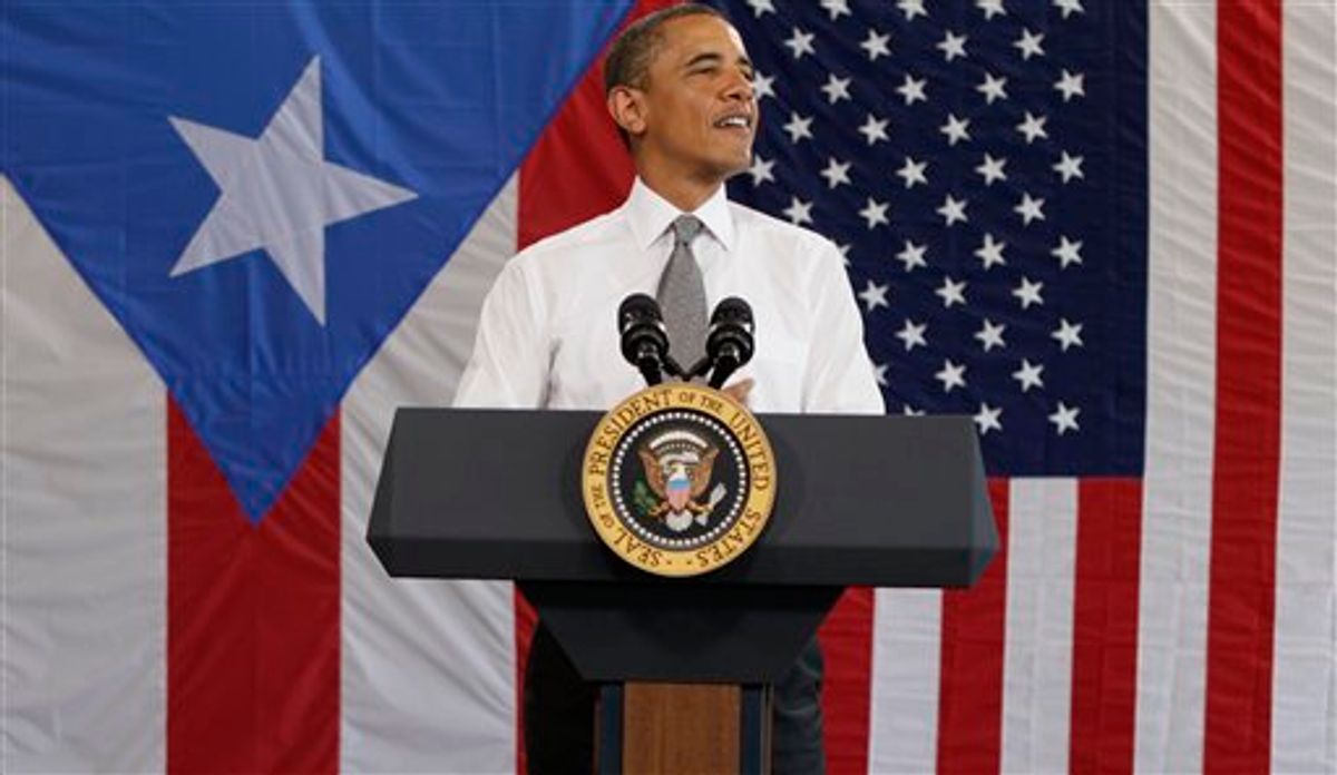 President Barack Obama speaks in an airport hanger at Muniz Air National Guard Base, Tuesday, June 14, 2011, in San Juan, Puerto Rico. (AP Photo/Carolyn Kaster) (AP)