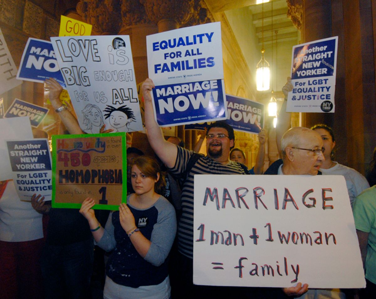Gay marriage supporters and opponents rally in the hallways at the Capitol in Albany, N.Y., Friday, June 24, 2011.   Security was tight in the Capitol as opponents and supporters of same-sex marriage clogged the marble hallways after a week of rising tensions and great expectations. (AP Photo/Hans Pennink) (Hans Pennink)