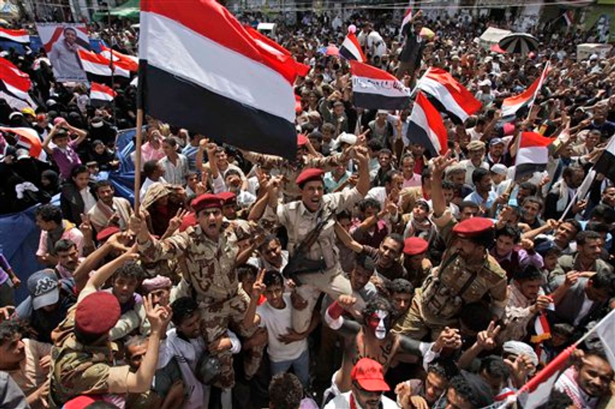 Yemeni army soldiers lifted by anti-government protestors, chants slogans and wave their national flag as they celebrate President Ali Abdullah Saleh's departure to Saudi Arabia, in Sanaa, Yemen, Sunday, June 5, 2011. Thousands of protesters are dancing and singing in the Yemeni capital Sanaa after the country's authoritarian leader flew to Saudi Arabia to receive medical treatment for wounds he suffered in a rocket attack on his compound. (AP Photo/Hani Mohammed) (AP)