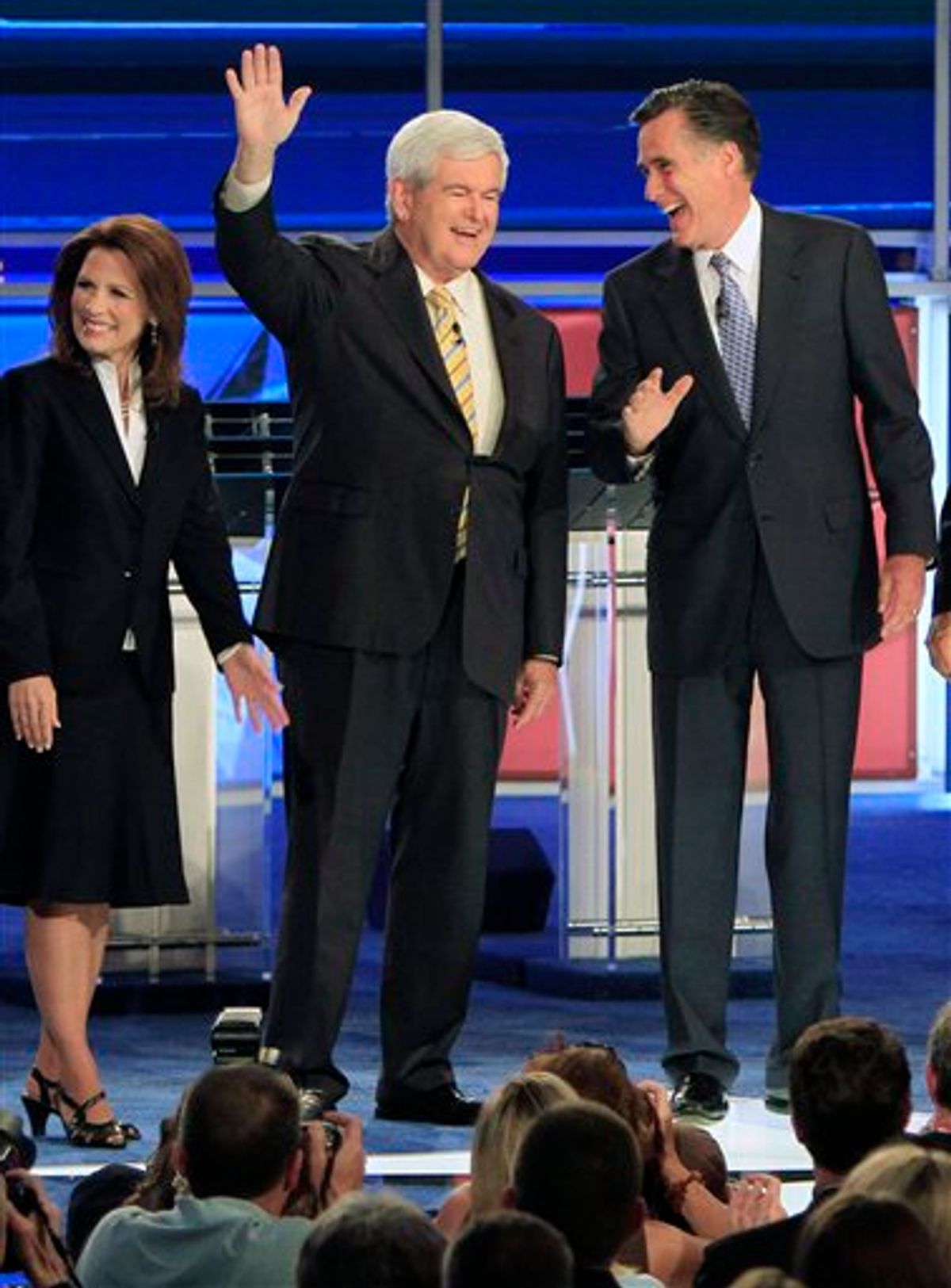 Former Massachusetts Gov. Mitt Romney, right, and former House Speaker Newt Gingrich share a laugh as they wave before the first New Hampshire Republican presidential debate at St. Anselm College in Manchester, N.H., Monday, June 13, 2011. Rep. Michele Bachmann, R-Minn., is at left. (AP Photo/Jim Cole)  (AP)