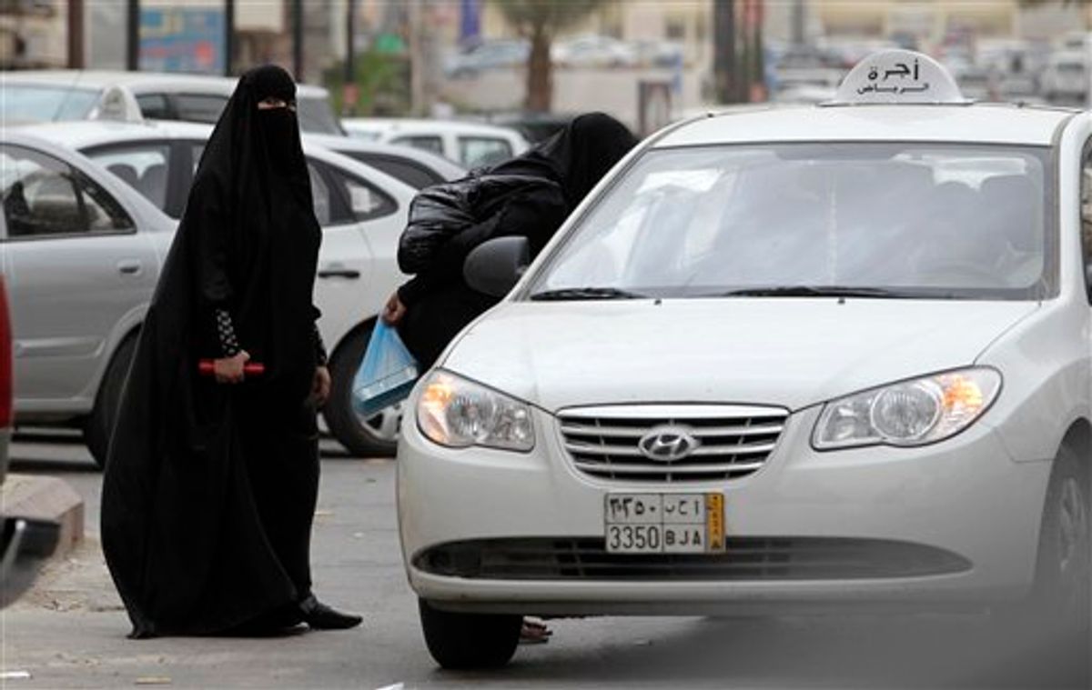 Saudi women board a taxi in Riyadh, Saudi Arabia, Tuesday, May 24, 2011. A Saudi woman was arrested for a second time for driving her car in what women's activists said Monday was a move by the rulers of the ultraconservative kingdom to suppress an Internet campaign encouraging women to defy a ban on female driving. Manal al-Sherif and a group of other women started a Facebook page called "Teach me how to drive so I can protect myself," urging authorities to lift the ban and posted a video clip last week of al-Sherif behind the wheel in the eastern city of Khobar. The page was removed after more than 12,000 people indicated their support for its call for women drivers to take to the streets in a mass drive on June 17.  (AP Photo/Hassan Ammar) (AP)