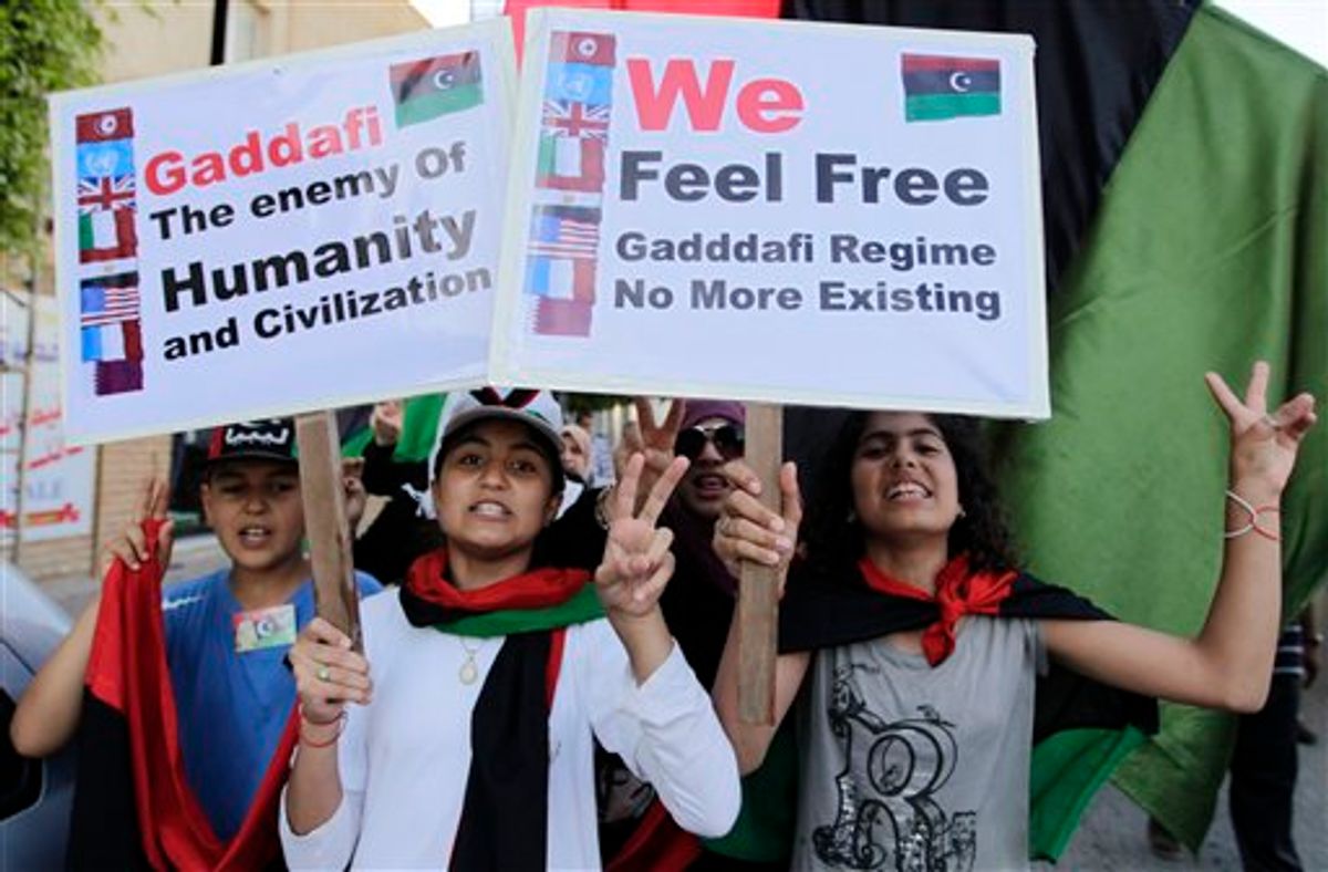 Libyan chant slogans against Moammar Gadhafi during a demonstration in the rebel-held capital Benghazi, Libya, Saturday, June 25, 2011. (AP Photo/Hassan Ammar) (AP)