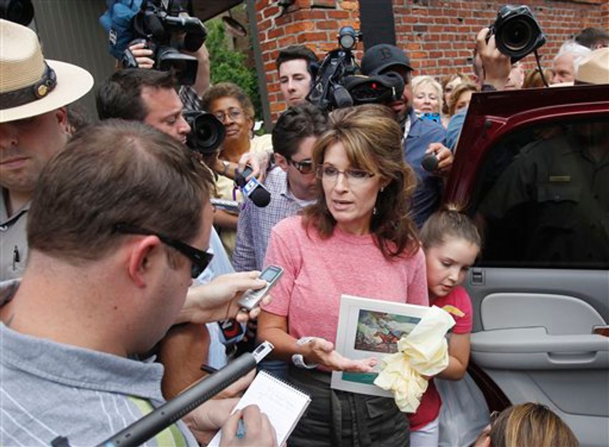 Former Alaska Gov. Sarah Palin, accompanied by her youngest daughter Piper, right, speaks briefly with the media as she tours Boston's North End neighborhood, Thursday,  June 2, 2011. (AP Photo/Steven Senne) (AP)