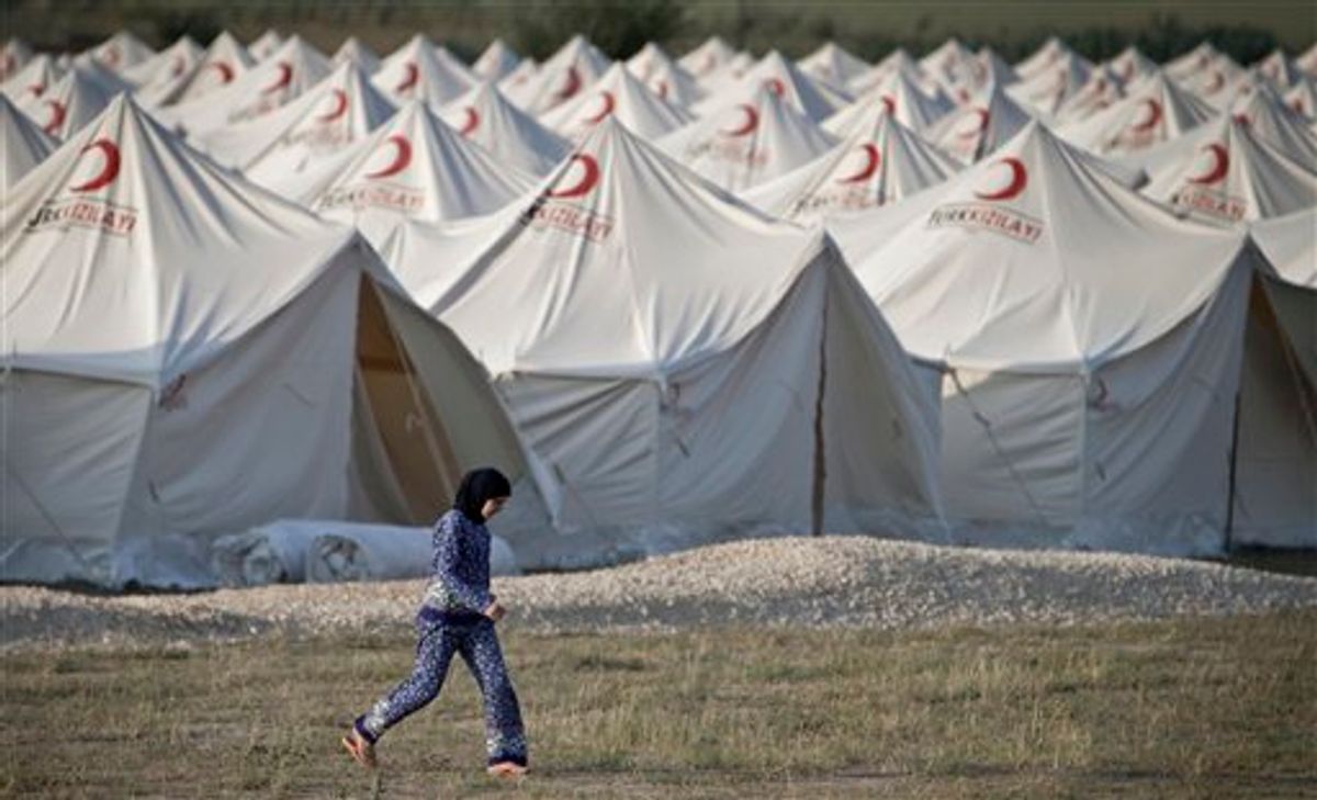 A Syrian refugee woman walks in the new refugee tent compound in Boynuyogun, Turkey, near the Syrian border, Sunday, June 12, 2011. Syrian forces launched a crackdown on the Syrian town of Jisr al-Shughour on Sunday, fueling fears that the clashes could spark a further influx of refugees towards bordering Turkey.(AP Photo/Vadim Ghirda) (AP)