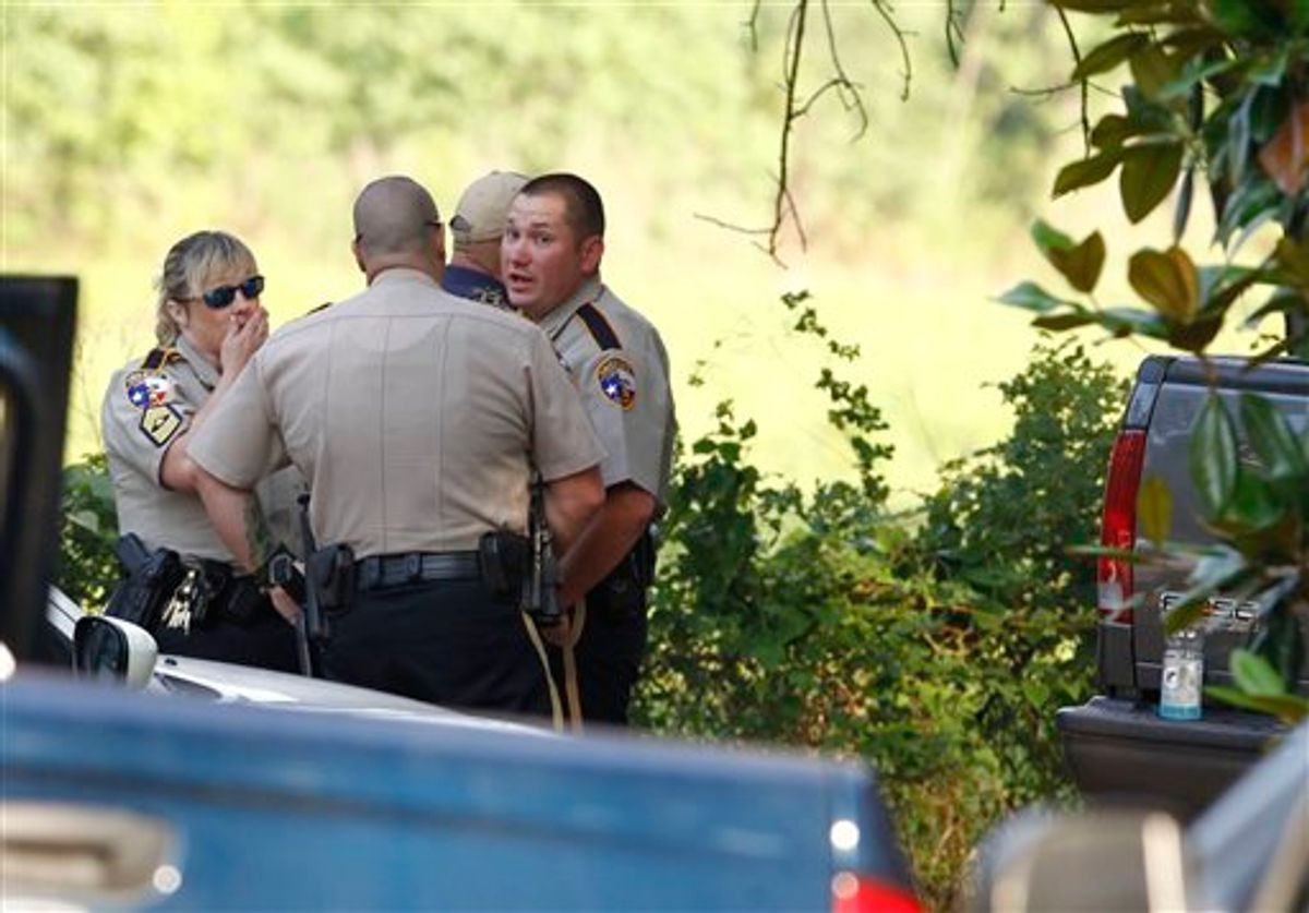 Law enforcement officials are on the scene of a home in Hardin, Texas Tuesday, June 7, 2011, after receiving an anonymous tip that multiple dismembered bodies were buried there. A sheriff's spokesman said officials were seeking a search warrant for the property. (AP Photo/Houston Chronicle, Nick de la Torre) (AP)