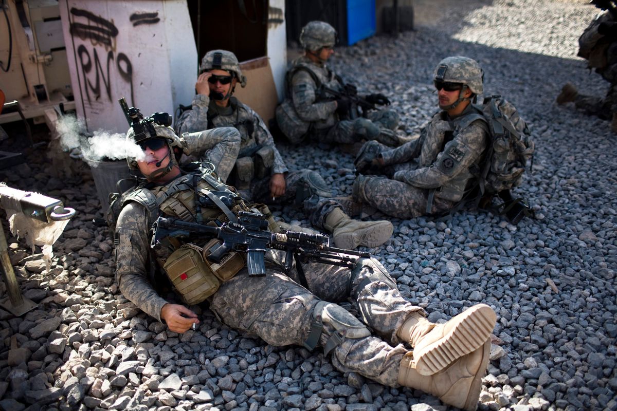 Unidentified US soldiers from L Troop, 4/2SCR, rest, before a foot patrol in Kandahar City, Afghanistan, Friday, Oct. 22, 2010. (AP Photo/Rodrigo Abd) (Associated Press)
