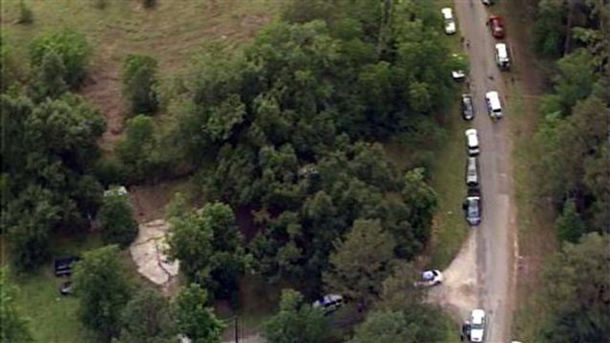 This image provided by KPRC-TV shows authorities at a rural house after receiving a tip that multiple dismembered bodies are buried there, in Liberty County, Texas, Tuesday, June 7, 2011. (AP Photo/KPRC-TV) MANDATORY CREDIT (AP)