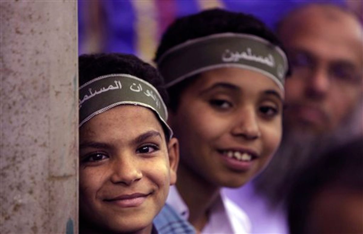 In this Wednesday, May 18, 2011 picture, two Egyptian boys wear headbands reading "Muslim Brotherhood" as they and other supporters attend a Muslim Brotherhood electoral rally in the Munib neighborhood of Cairo, Egypt. Once forced underground, the Brotherhood is likely to be part of Egypt's new government, fueling fears of Islamic rule. But the Brotherhood's own identity is on the line, and there is pressure from inside and out for it not to go down a sharp-right Islamic road. (AP Photo/Nasser Nasser) (AP)