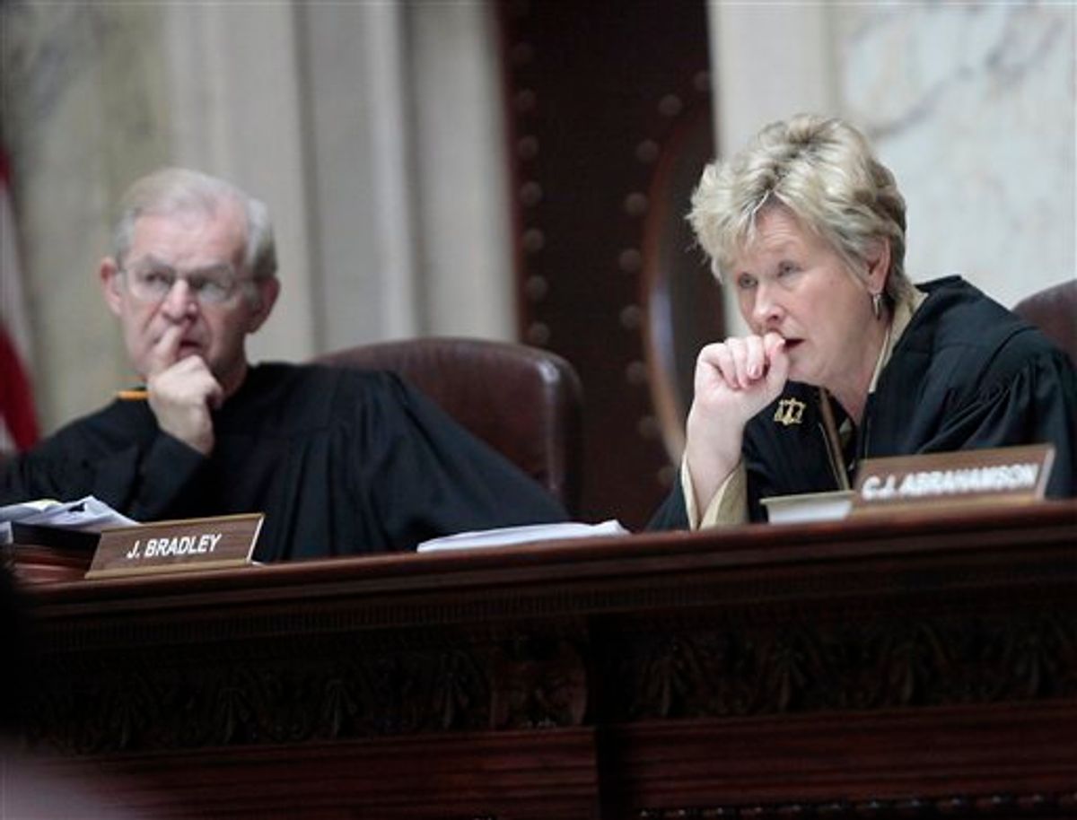 Wisconsin Supreme Court Justices David T. Prosser, Jr. and Ann Walsh Bradley consider oral arguments during a hearing regarding the state's budget bill at the Wisconsin State Capitol, Monday, June 6, 2011. According to a report by Wisconsin Public Radio and the Wisconsin Center for Investigative Journalism, Prosser allegedly grabbed Bradley by the neck with both hands during an argument in Walsh's chambers prior to the court's decision to uphold the bill. (AP Photo/John Hart, Pool) (AP)