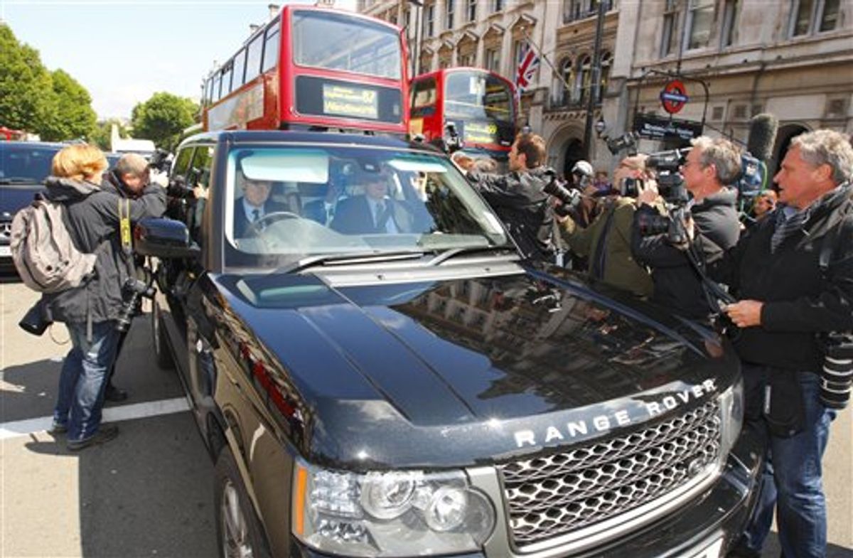 Photographers and cameramen surround the vehicle carrying Rupert Murdoch along Whitehall in London, Tuesday July 19, 2011, ahead of his and his son James' appearance before a House of Commons committee to face their intensely-awaited grilling on the News of the World phone-hacking scandal. (AP Photo/Chris Ison-pa)  UNITED KINGDOM OUT: NO SALES: NO ARCHIVE:  - PHOTOGRAPH CAN NOT BE STORED OR USED FOR MORE THAN 14 DAYS AFTER THE DAY OF TRANSMISSION (AP)