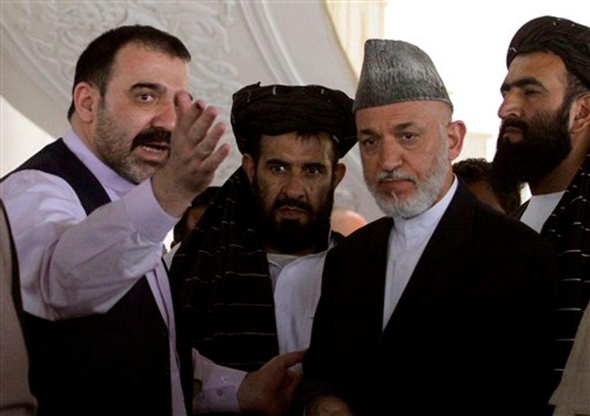 FILE  - In this Saturday, Oct. 9, 2010 file photo Afghan President Hamid Karzai, second from right, is met by his half brother Ahmad Wali Karzai, left, in Argandab district of Kandahar province, south of Kabul, Afghanistan. An Afghan official says Afghan President Hamid Karzai's half brother has been killed in southern Afghanistan. Zalmai Ayubi, the spokesman for Kandahar province, says that Ahmad Wali Karzai was shot dead on Tuesday July 12, 2011. Ahmad Wali Karzai, who was head of the Kandahar provincial council, had become a political liability for the Karzai government _ a symbol of cronyism and a lightning rod for criticism of all that is wrong with the Karzai administration. (AP Photo/Allauddin Khan, file)    (Associated Press)