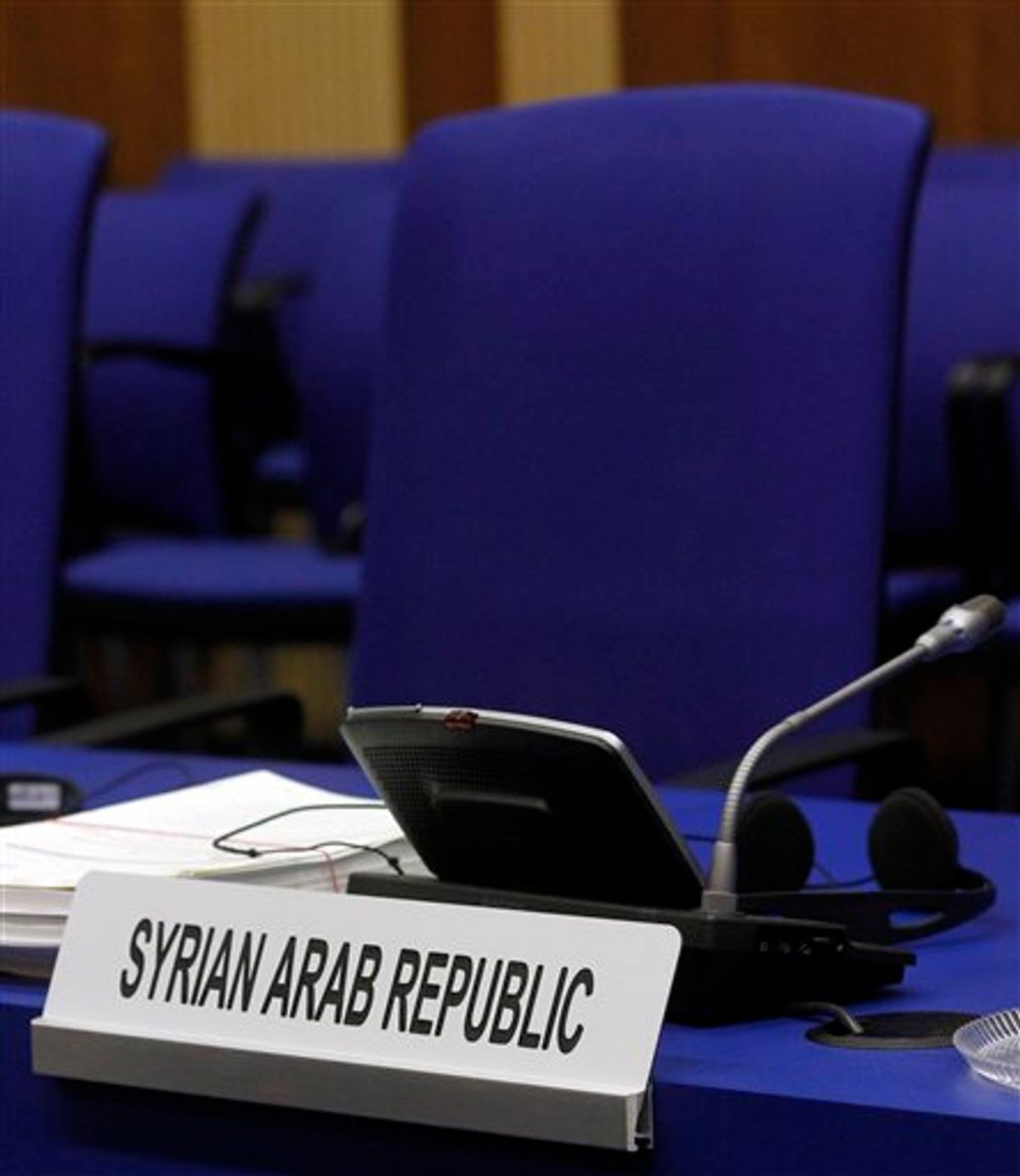 The empty chair of Syria's ambassador to Austria Bassam al-Sabbagh at the start of International Atomic Energy Agency, IAEA's board of governors meeting at the International Center, in Vienna, Austria, on Wednesday, June 8, 2011. (AP Photo/Ronald Zak) (AP)