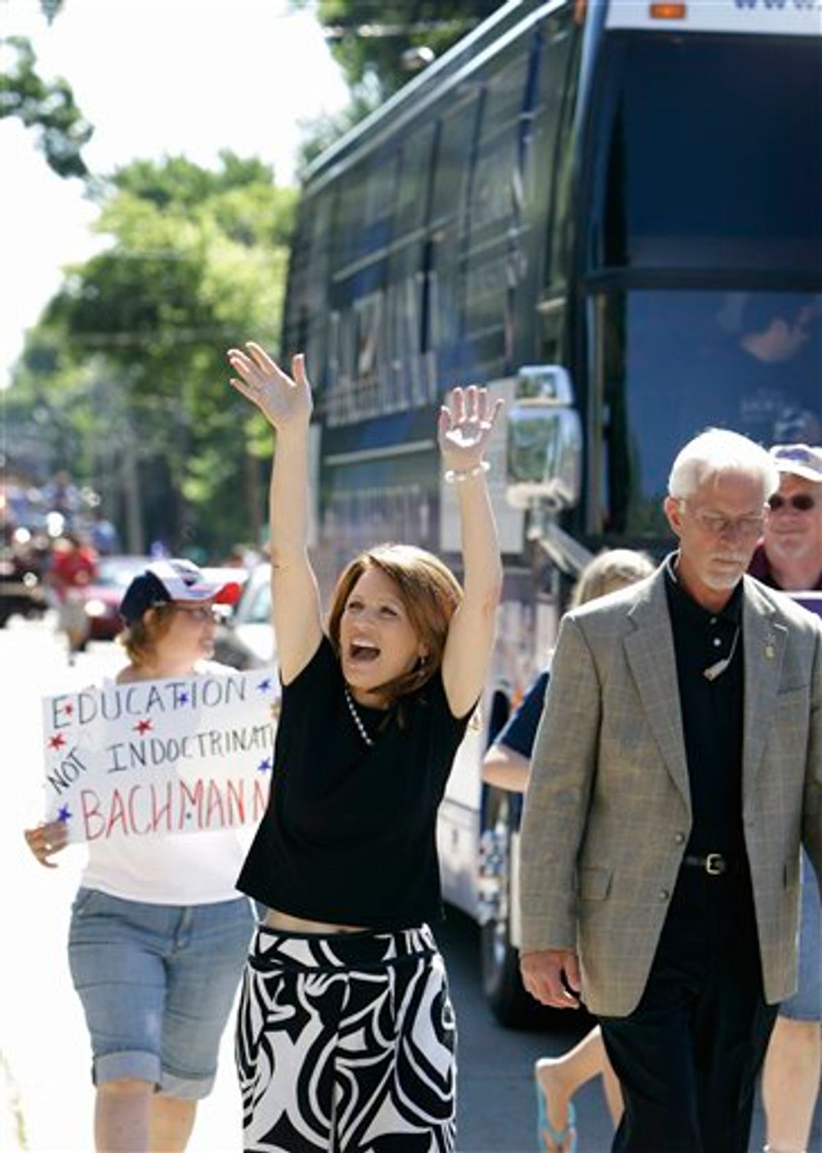Republican presidential candidate, Rep. Michele Bachmann, R-Minn., waves while walking in the Fourth of July parade in Clear Lake, Iowa., Monday, July 4, 2011.  (AP Photo/Charlie Neibergall) (AP)