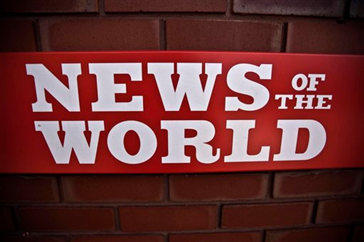 FILE - This is a  Wednesday, July 6, 2011 file photo of  a News of the World sign is seen by an entrance at premises of News International in London. James Murdoch  News Corporation executive says the News of the World will publish its last issue on Sunday.  The focus of the phone hacking scandal shifted Thursday to serious allegations of police corruption as Scotland Yard called for an independent review of reported payoffs by journalists to police.  The review announced Thursday by the Independent Press Complaints Commission reflects the seriousness of the corruption charges, which are apparently based on information provided by the embattled News of the World tabloid to police in recent days. (AP Photo/Matt Dunham) (AP)