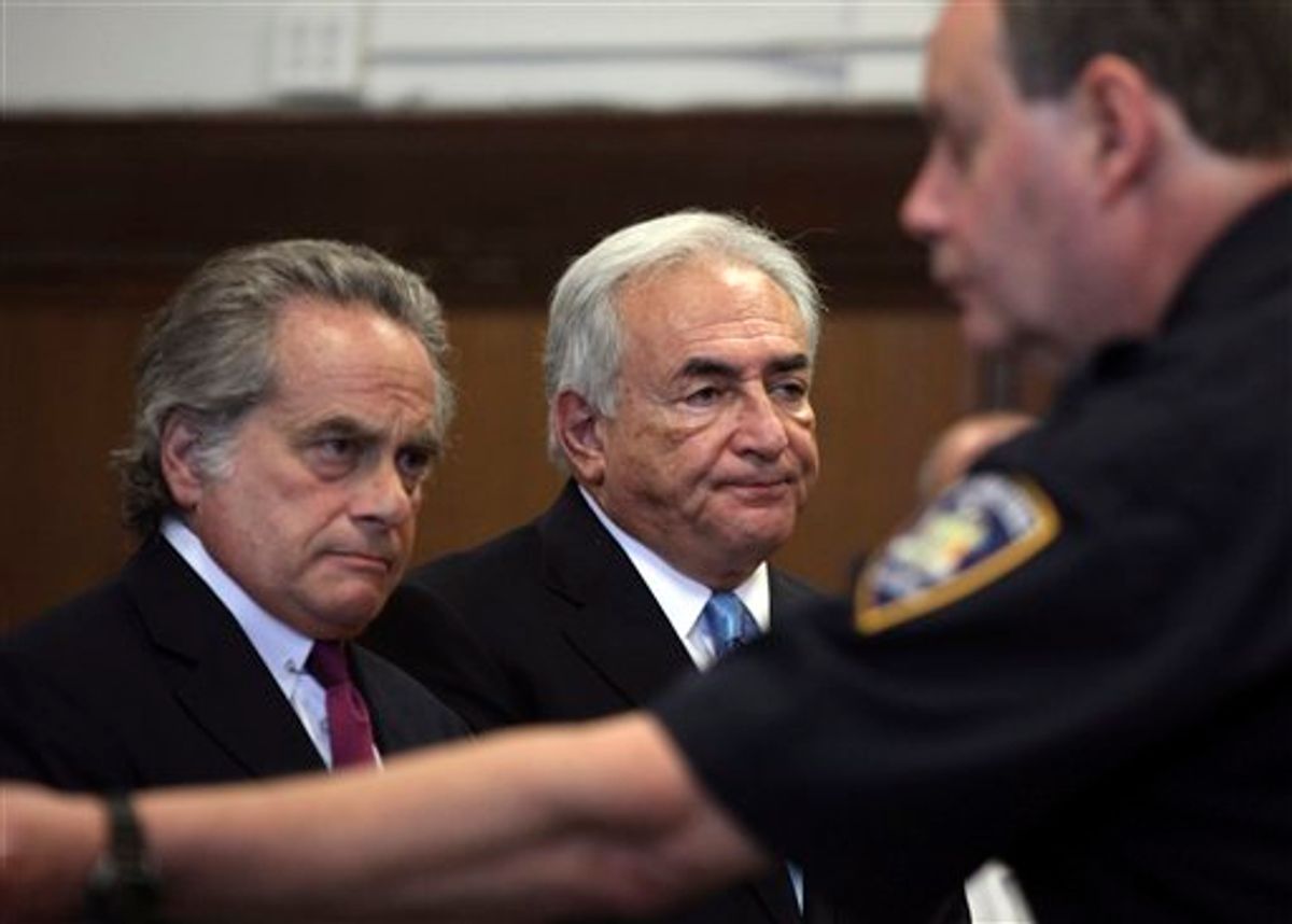 Former International Monetary Fund leader Dominique Strauss-Kahn, center, and his attorney Benjamin Brafman  listen to proceedings in New York state Supreme Court in New York, Friday, July 1, 2011.  A judge has agreed to free former International Monetary Fund leader Strauss-Kahn without bail or home confinement in the sexual assault case against him.  The criminal case against him stands.   (AP Photo/Todd Heisler, Pool) (AP)