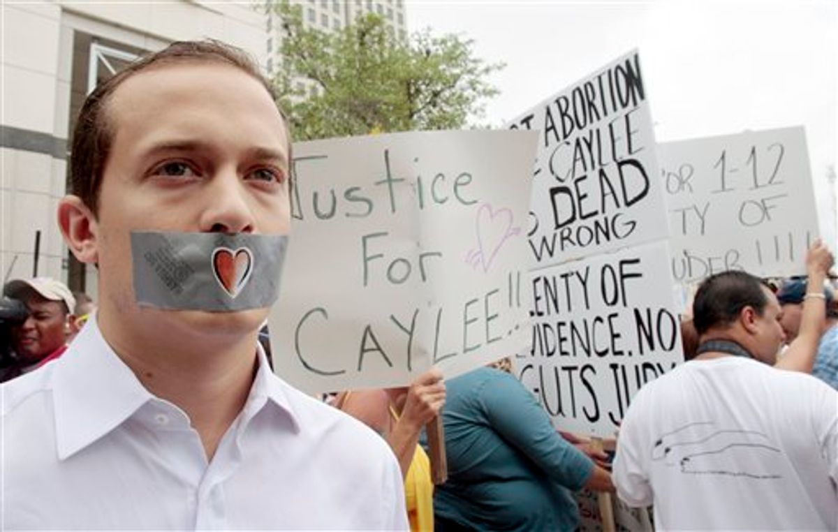 Edward Mehnert, of Orlando, covers his mouth with duct tape as he protests during the Casey Anthony sentencing in outside the Orange County Courthouse in Orlando, Fla., Thursday, July 7,  2011. A court official says Casey Anthony is going to be released from jail next Wednesday following her conviction for lying to authorities who were investigating the death of her 2-year-old daughter,  Caylee. (AP Photo/Alan Diaz) (AP)