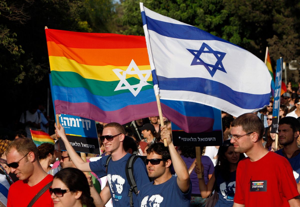 Participants hold flags during the gay pride parade in Jerusalem July 29, 2010. This year's parade marks the one-year anniversary of a shooting attack in a gay and lesbian youth center in Tel Aviv, in which two people were killed and 13 were injured. REUTERS/Ronen Zvulun (JERUSALEM - Tags: POLITICS SOCIETY)      (Reuters)