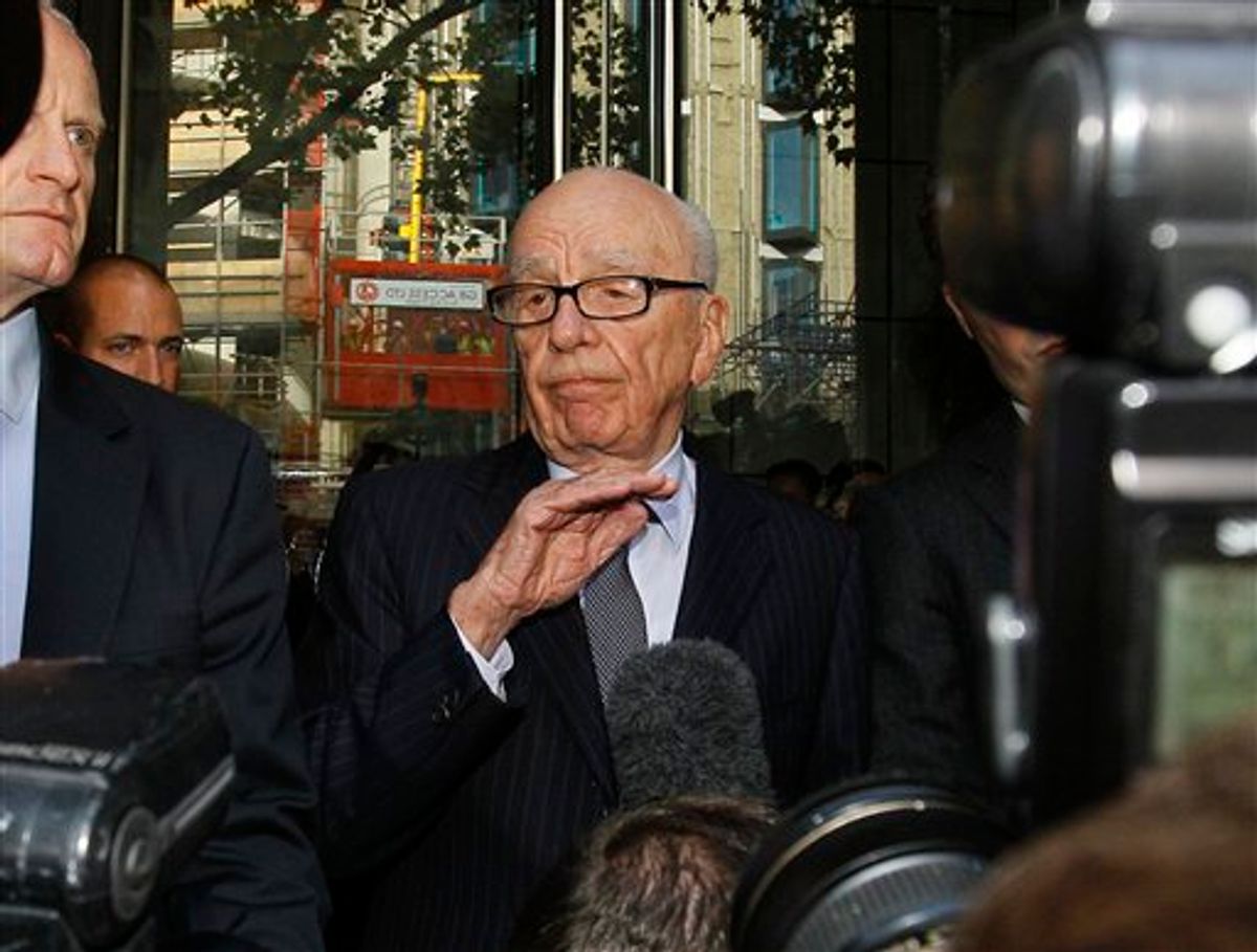 Rupert Murdoch, centre, attempts to speak to the media after he held a meeting with the parents and sister of murdered school girl Milly Dowler in London, Friday, July 15, 2011. The lawyer for the Milly Dowler's family says Rupert Murdoch has issued a full and sincere apology to the murdered schoolgirl's family for the actions of journalists at his newspaper. Mark Lewis told reporters that the media baron called the private meeting and apologized "many times," telling the Dowlers the events that transpired at the News of the World tabloid were not in keeping with the standards set out when his own father entered the media industry.(AP Photo/Kirsty Wigglesworth)      (AP)