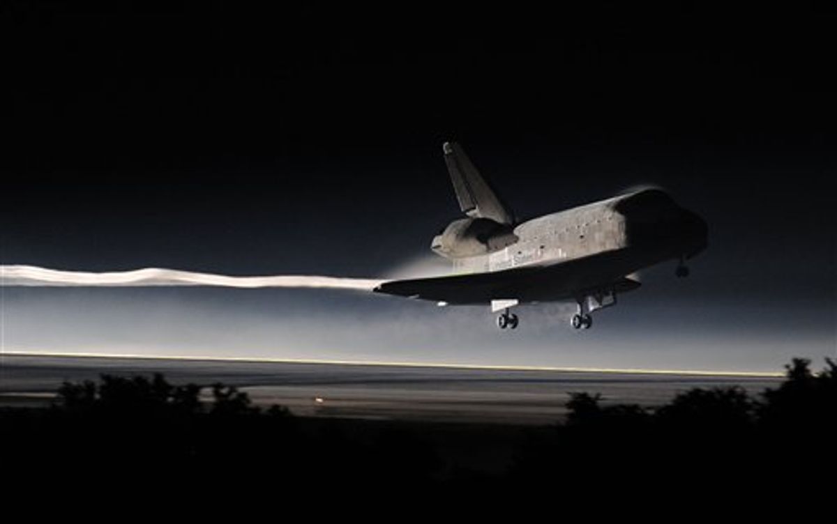 Space Shuttle Atlantis lands at the Kennedy Space Center at Cape Canaveral, Fla. Thursday, July 21, 2011. The landing of Atlantis marks the end of NASA's  30 year space shuttle program.  (AP Photo/Don Emmert, Pool)  (AP)