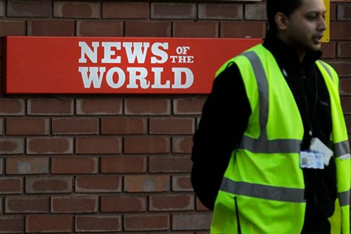 A security officer stands at the gates outside the publisher of News of the World, News International's headquarters in London, Thursday, July 7, 2011.  Sunday newspaper News of the World is accused of hacking into the mobile phones of crime victims, celebrities and politicians, prompting News International to announce Thursday that the papers is to cease publication after publication upcoming Sunday. (AP Photo/Sang Tan) (AP)
