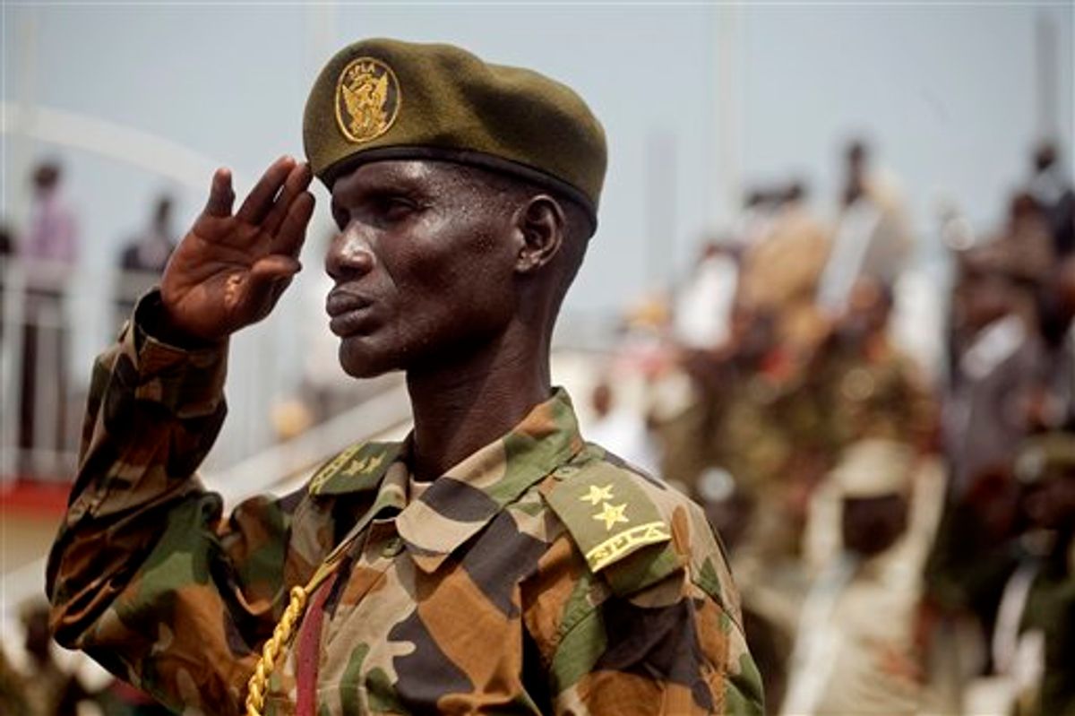 A Southern Sudanese soldiers stands at attention during the national anthem during an independence rehearsal procession in Juba, southern Sudan on Thursday, July 7, 2011. The Government of Southern Sudan is making lavish preparations to celebrate its declaration of independence from the north on Saturday, July 9th. The south's secession comes after decades of brutal civil war between north and south that resulted in more than two million deaths, most of which were southerners. (AP Photo/Pete Muller)  (AP)