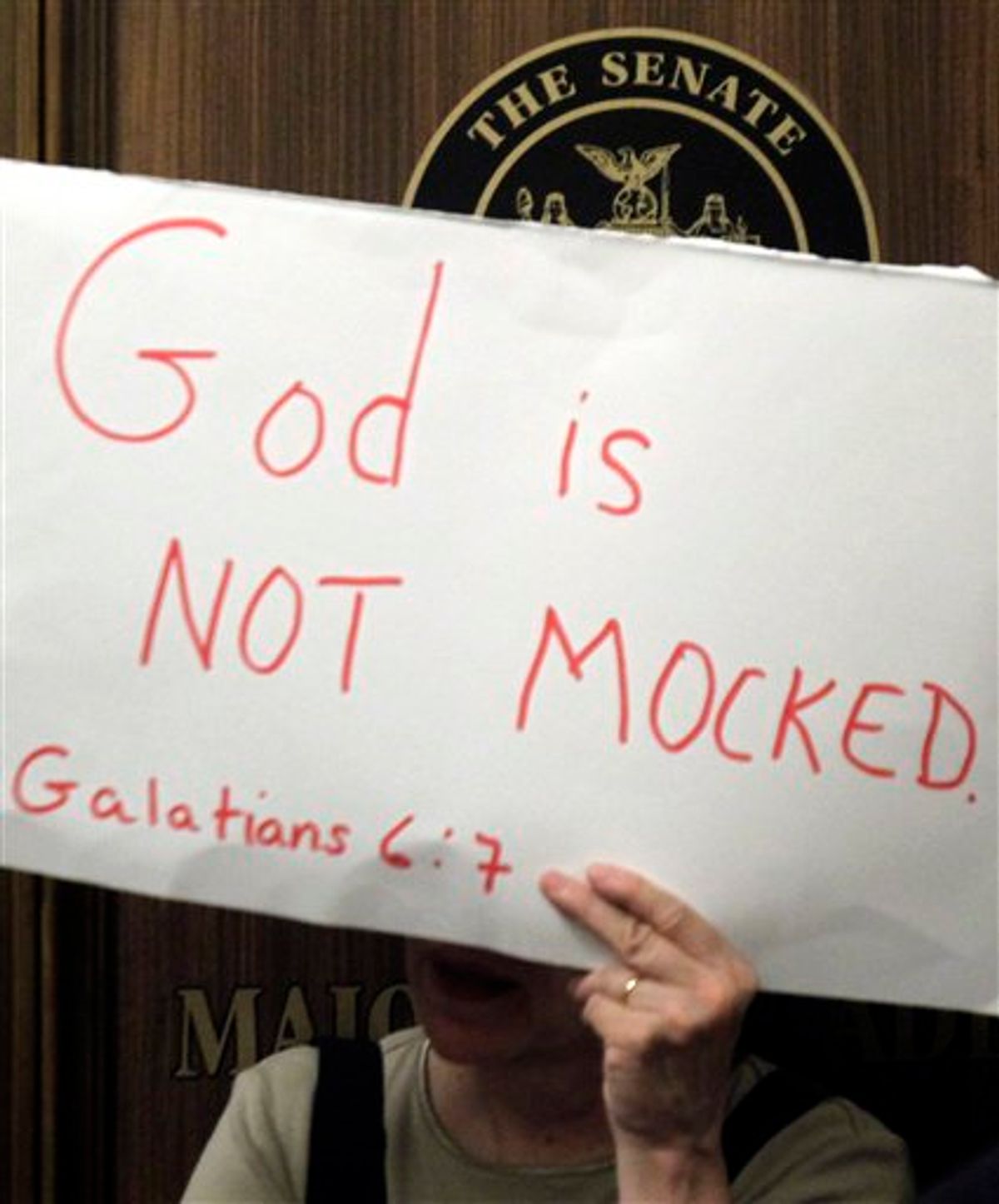 A woman holds a sign as supporters and opponents of gay marriage rallied in a hallway outside a Republican conference room at the Capitol in Albany, N.Y., on Wednesday, June 22, 2011.   Senate leader Dean Skelos and Assembly Speaker Sheldon Silver agree they are working through the proposed additional religious protections that could bring a gay marriage bill to the Senate floor.  No deal was struck. But both leaders say progress is being made and no major obstacles to agreement on the provisions is in sight.  (AP Photo/Mike Groll)  (AP)