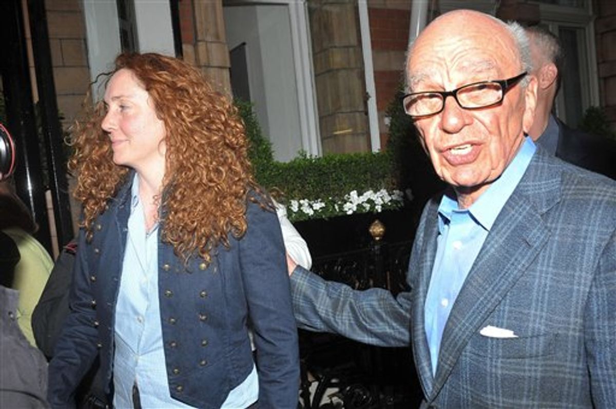 News International chief executive Rebekah Brooks, left, and Rupert Murdoch are seen outside the central London residence of News Corporation chairman Rupert Murdoch, Sunday July 10, 2011.  News Corp title News of the World newspaper ceased publication with today's issue, following accusations of alleged hacking into the mobile phones of various crime victims, celebrities and politicians. (AP Photo/Ian Nicholson, PA) UNITED KINGDOM OUT - NO SALES - NO ARCHIVES (AP)