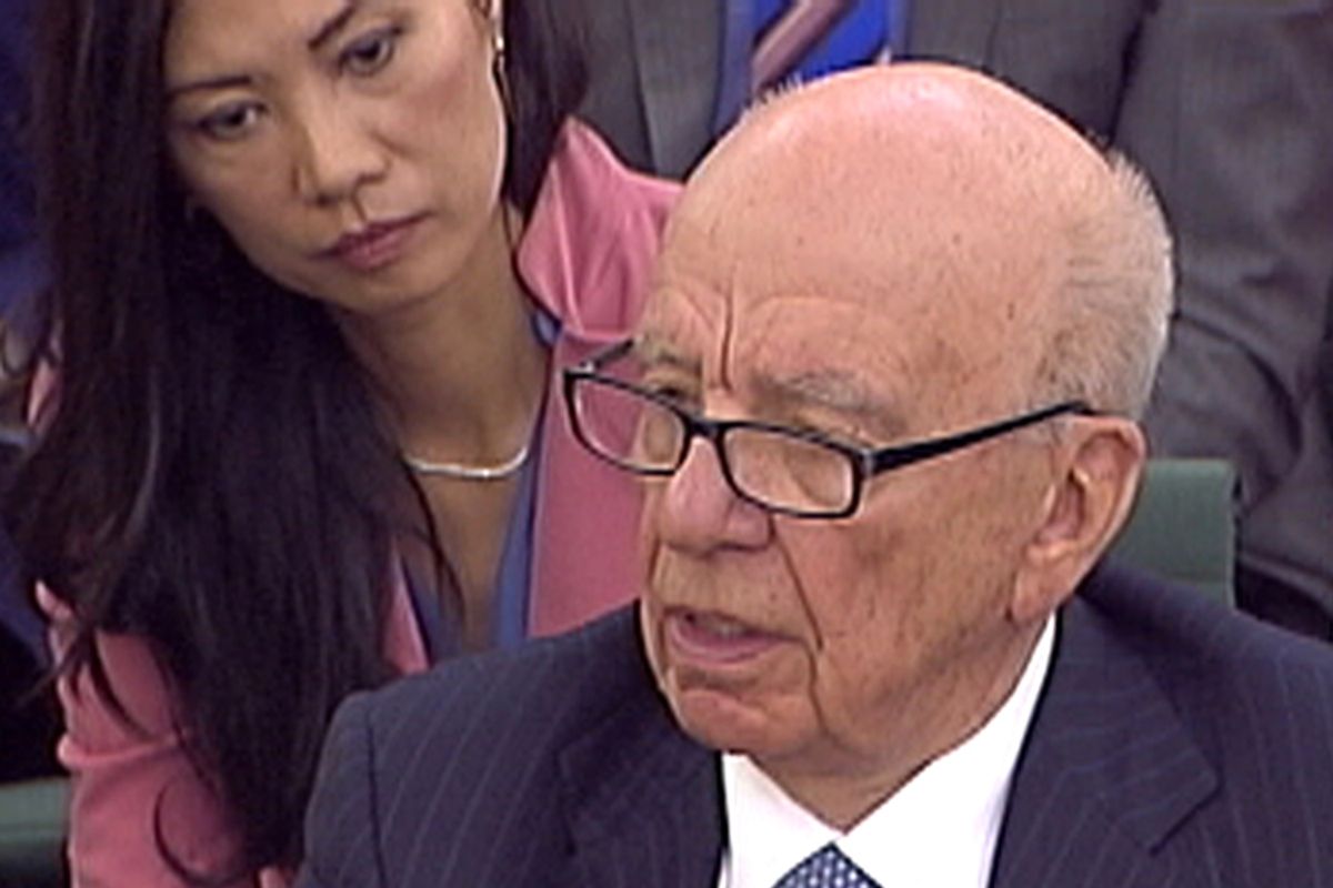 Wendi Deng ( L) watches as her husband, News Corp Chief Executive and Chairman Rupert Murdoch, is questioned during a parliamentary committee hearing on phone hacking at Portcullis House in London July 19, 2011.  Later, Murdoch was attacked by a protester on Tuesday while giving evidence to a British parliamentary committee at which he defended his son and his company over a scandal that has rocked the British establishment. REUTERS/Parbul TV via Reuters Tv (BRITAIN - Tags: CRIME LAW MEDIA BUSINESS) FOR EDITORIAL USE ONLY. NOT FOR SALE FOR MARKETING OR ADVERTISING CAMPAIGNS       (Â© Reuters Tv / Reuters)
