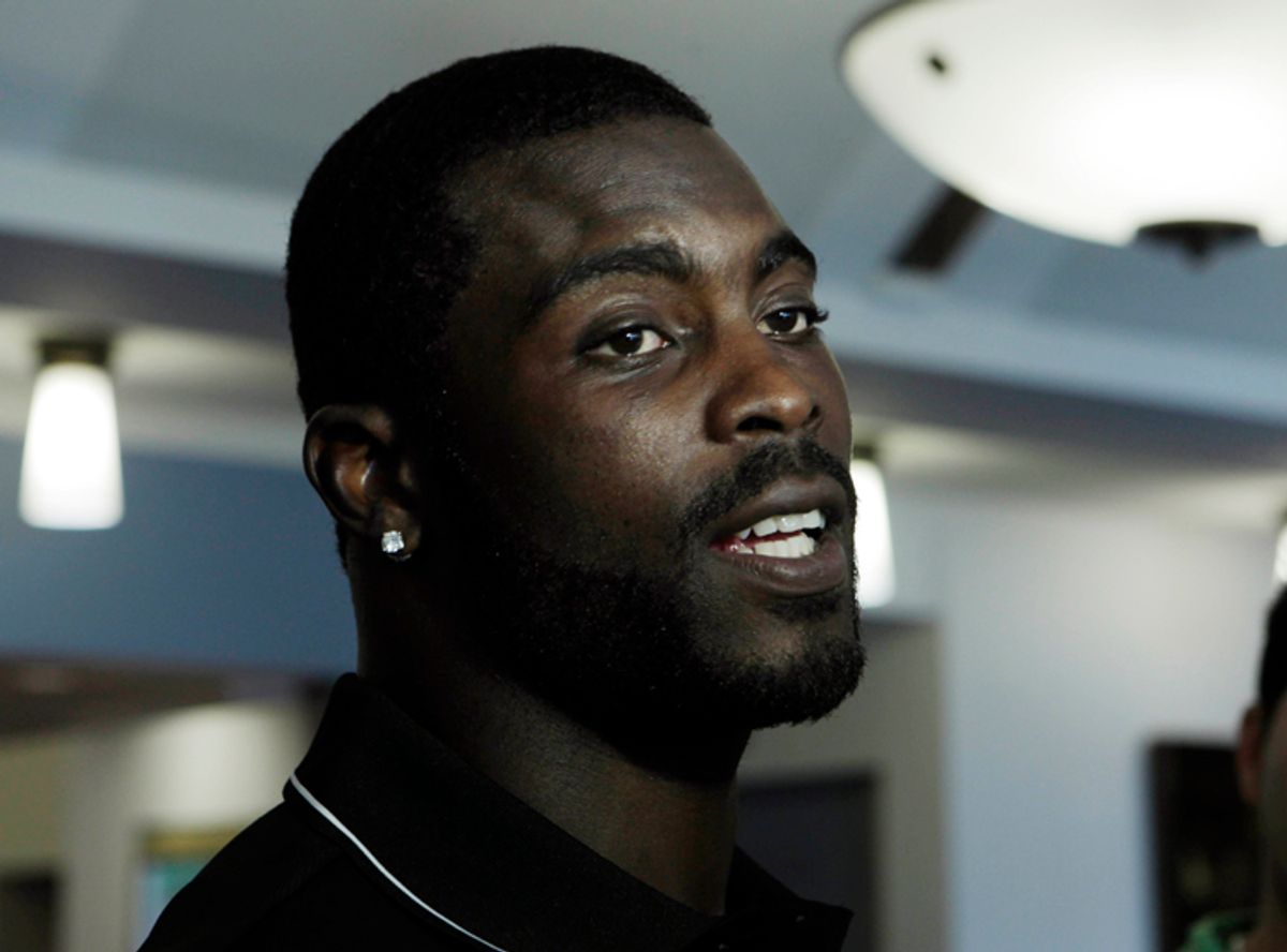 Philadelphia Eagles quarterback Michael Vick answers a question in Philadelphia, Wednesday, June 8, 2011, he says that he uses Unequal Technologies EXO Skeleton products that protect players like him from sports-related hard-hit injuries. (AP Photo/Mel Evans)  (Mel Evans)