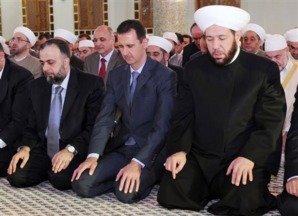 In this photo released by the Syrian official news agency SANA, Syrian President Bashar Assad, center, prays during the Eid al-Fitr prayer at Hafez al-Assad mosque, in Damascus, Syria, on Tuesday Aug. 30, 2011. Syrian security forces killed seven people on Tuesday as they opened fire to disperse thousands of protesters rallying against the regime on the first day of a Muslim holiday that marks the end of the fasting month of Ramadan, activists said. (AP Photo/SANA) EDITORIAL USE ONLY (AP)