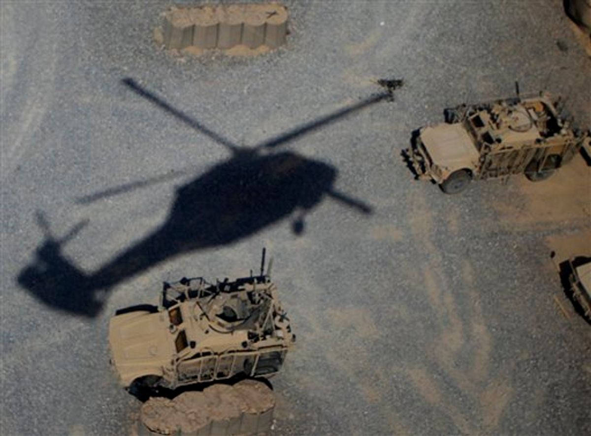 The shadow of a medevac helicopter from the U.S. Army's Task Force Shadow "Dust Off", Charlie Company 1-52, comes in to land on a mission on the outskirts of Kandahar, Afghanistan, Friday Aug 5, 2011.(AP Photo/Rafiq Maqbool) (AP)