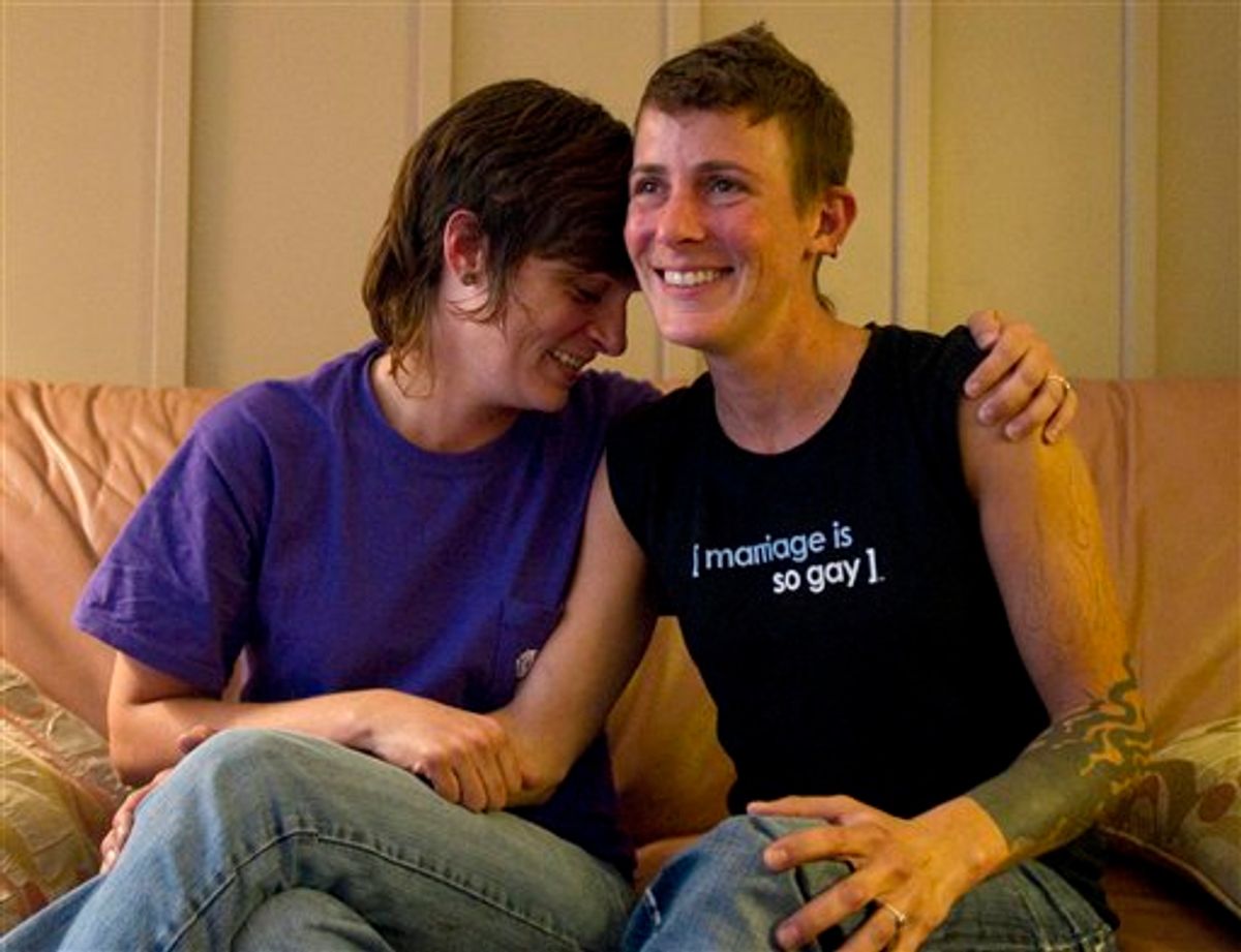 In a July 25, 2011 photo, lesbian couple Jennifer Tipton, left, and Olivier Odom are seen at a coffee house in Knoxville, Tenn. The couple are calling for Dollywood Splash County to be more inclusive to its guests after they were asked to reverse the pro-gay marriage T-shirt worn by Odom, during a recent visit.  (AP Photo/Knoxville News Sentinel, Saul Young)  (AP)