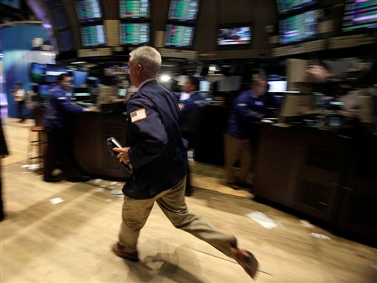 A trader strides across the floor of the New York Stock Exchange at the closing bell, Tuesday, Aug. 9, 2011. The Dow Jones industrial average closed up 429.92 points. (AP Photo/Richard Drew) (AP)