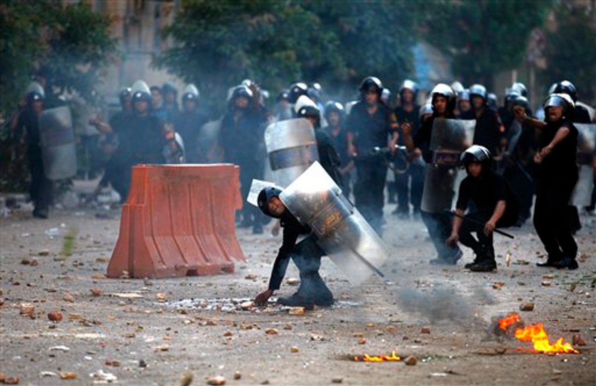 Egyptian riot police and demonstrators throw stones at each other during clashes in Cairo, early Wednesday, June 29, 2011 