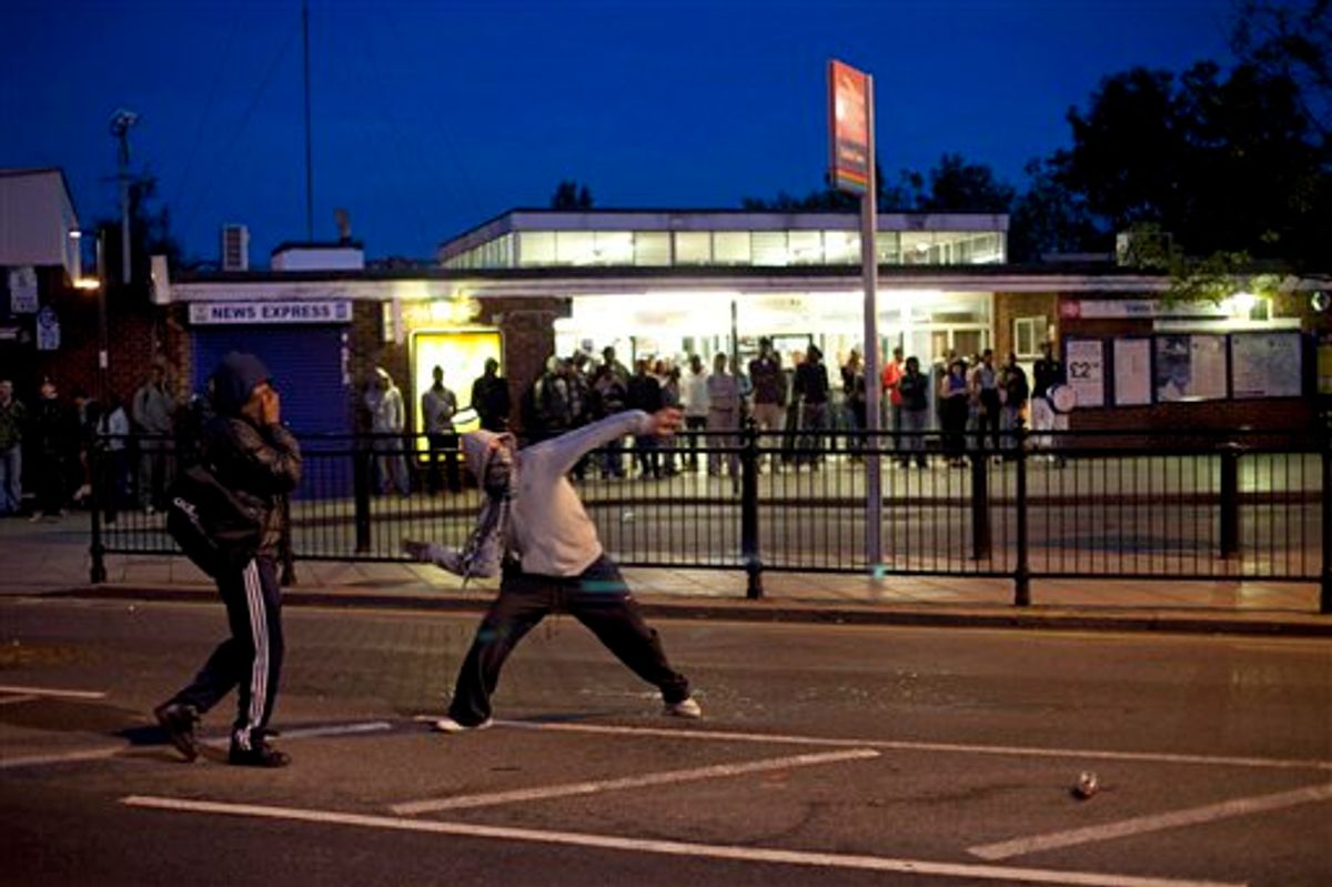 Youths throw bricks at police Sunday, Aug. 7, 2011 during unrest in Enfield, North London. New unrest erupted on north London's streets late Sunday, a day after rioting and looting in a deprived area amid community anger over a fatal police shooting. (AP Phto/Karel Prinsloo)  (AP)