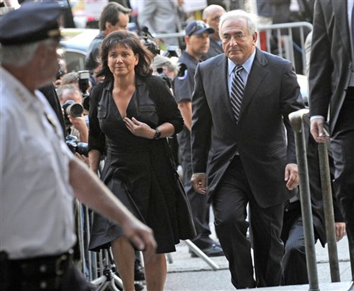 Dominique Strauss- Kahn arrives at Manhattan State Supreme court with his wife Anne Sinclair, Tuesday, Aug. 23, 2011, in New York. Strauss- Kahn, the former head of the International Monetary Fund, is hoping that the judge will agree to dismiss the sexual assault case brought against him by a hotel housekeeper. (AP Photo/Louis Lanzano) (AP)