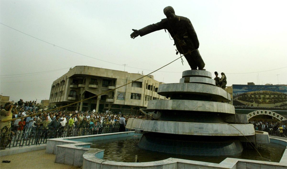 Iraqi citizens pull down a statue of Iraqi President Saddam Hussein in April, 2003.