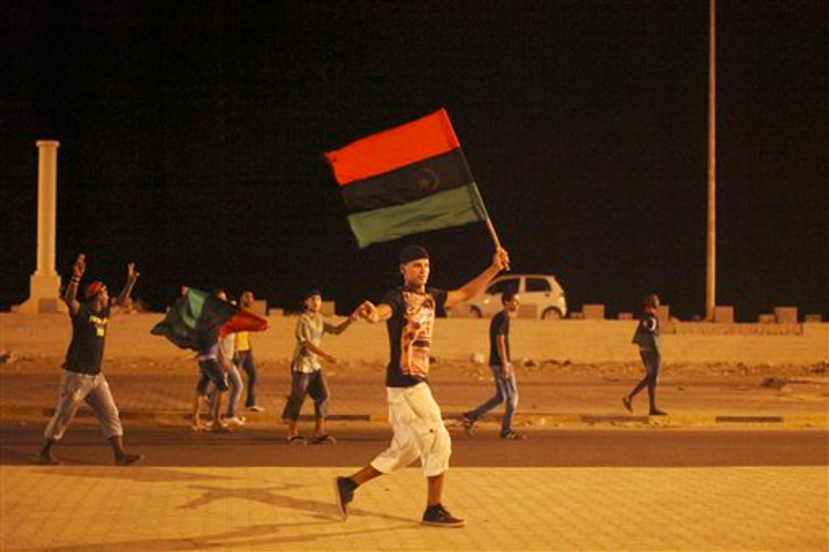 Libyans celebrate the capture of Moammar Gadhafi's son and one-time heir apparent, Seif al-Islam, on Monday, Aug. 22, 2011   
