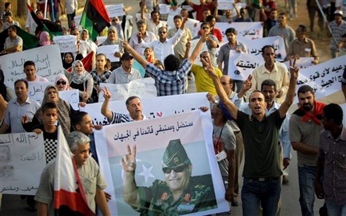 Libyans shout slogans at a rally outside the Tibesti hotel in the rebel-held Benghazi, Libya, Sunday, July 31, 2011. The rally was held to pay respect to Libyan rebels' slain military chief Abdel-Fattah Younis. (AP Photo/Sergey Ponomarev) (AP)