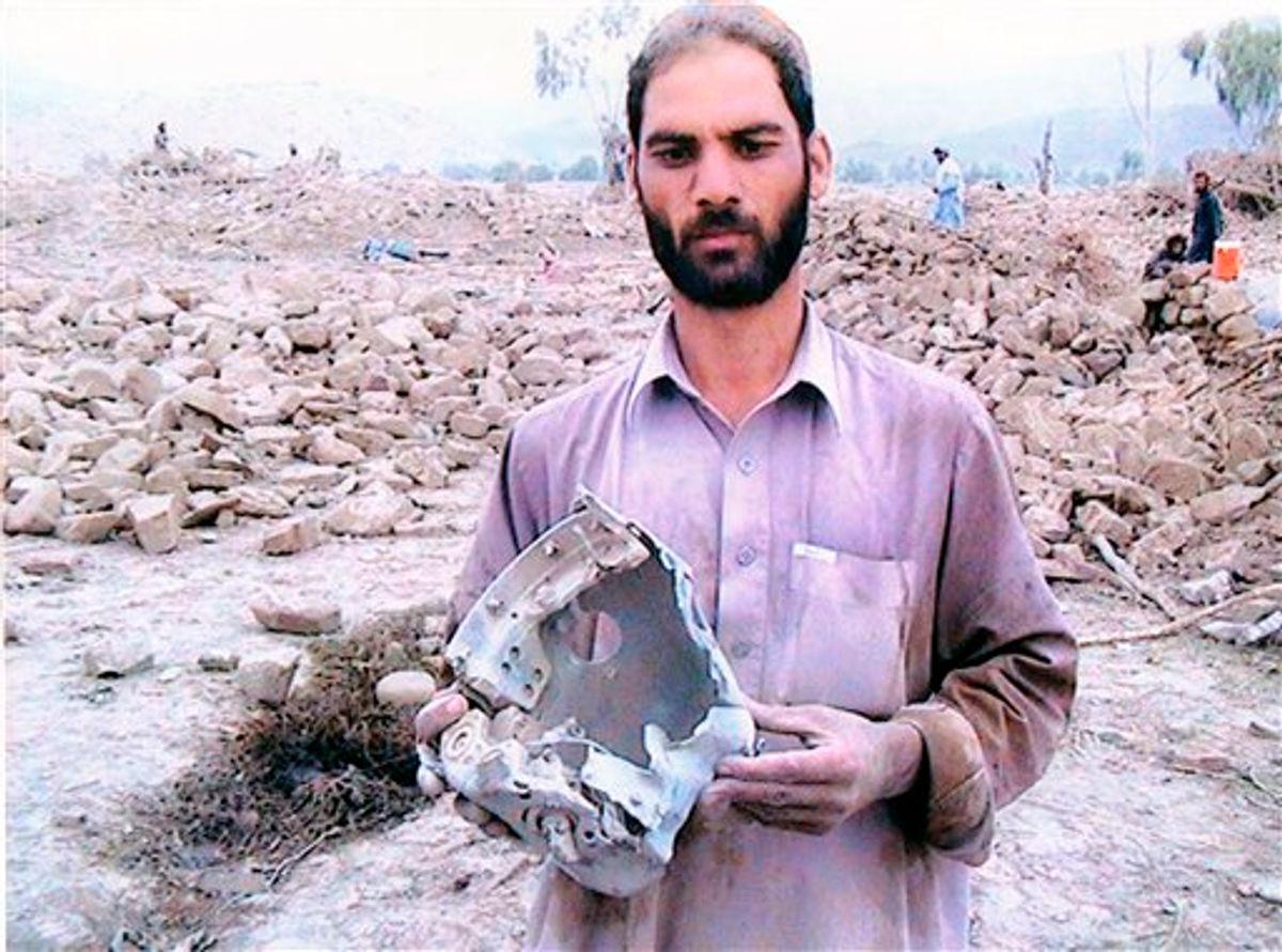 In this Aug. 23, 2010 photo provided by photographer Noor Behram, a man holds debris from a missile strike in North Waziristan, Pakistan. A gallery in London is staging an exhibit of photographs taken by a Pakistani photographer allegedly showing innocent civilians killed by U.S. drone missile strikes in Pakistan's tribal region along the Afghan border, the organizers said Monday. Noor Behram, a 39-year-old photographer who has worked with several international news agencies, has spent the last three years photographing the aftermath of drone strikes in North and South Waziristan, important sanctuaries for al-Qaida and Taliban militants in Pakistan. He said he has managed to reach around 60 attack sites, and the exhibit that opens Tuesday at the Beaconsfield gallery in London features photographs from 28 of those strikes. (AP Photo/Noor Behram,HO)    (AP)