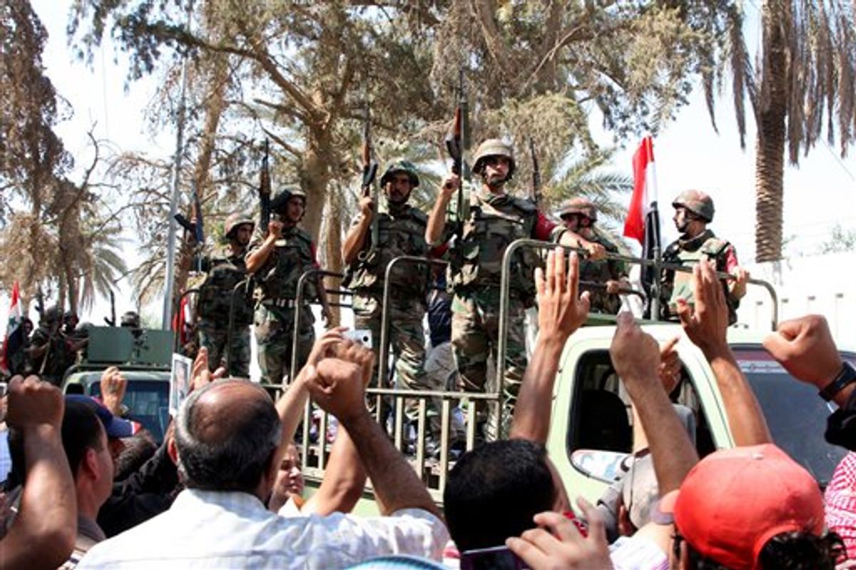 In this photo taken on a government-organized tour, residents cheer Syrian soldiers on military vehicles as they leave the eastern city of Deir el-Zour, Syria, Tuesday, Aug. 16, 2011. State-run news agency SANA said army units began withdrawing from Deir el-Zour Tuesday after ridding the city of "armed terrorist gangs" in an operation that lasted several days. (AP Photo/Bassem Tellawi) (AP)