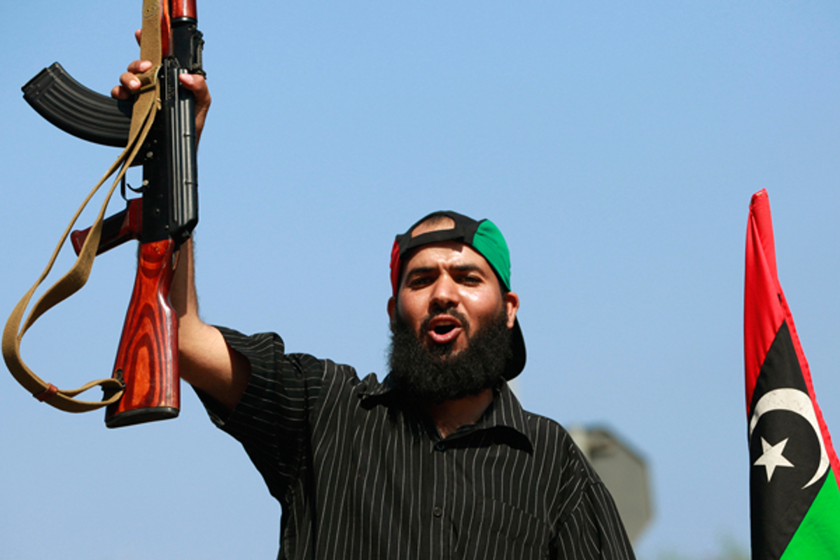 A Libyan rebel fighter celebrates as they drive through Tripoli's Qarqarsh district August 22, 2011