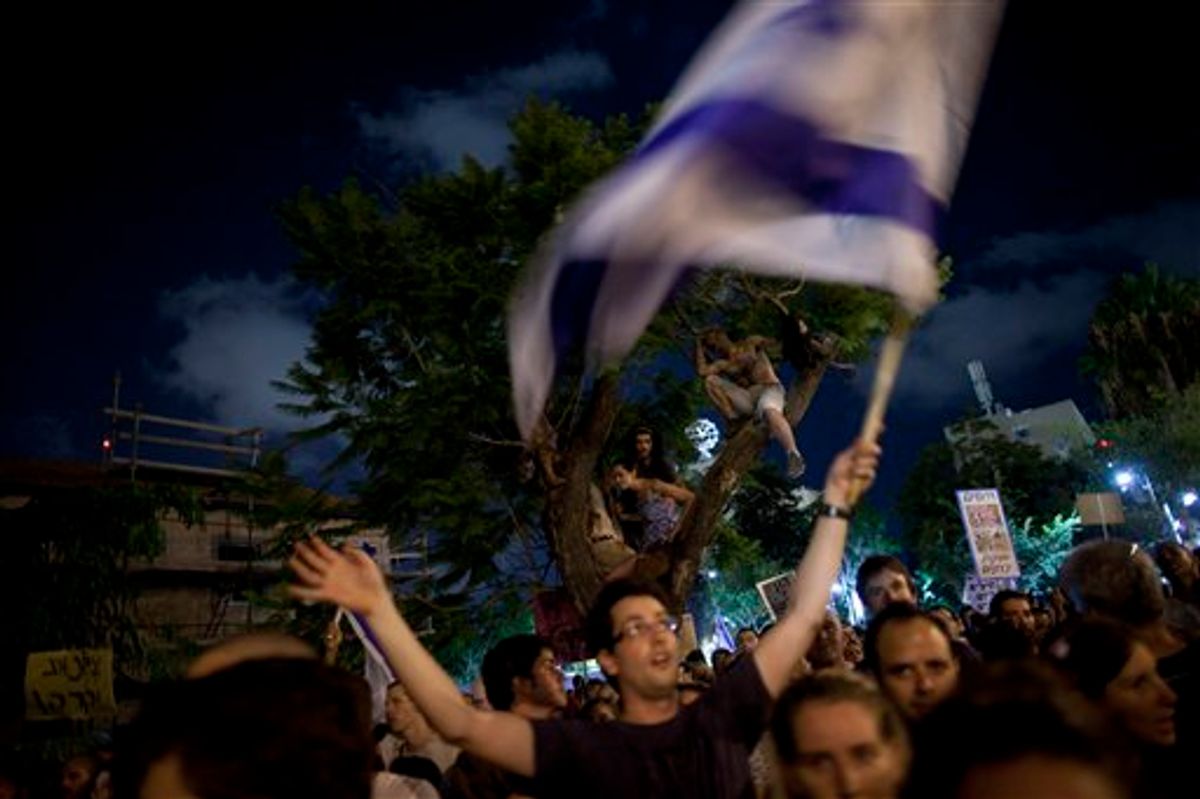 Thousands of Israelis march during a protest against the rising cost of living in Israel, in central Tel Aviv, Israel, Saturday, Aug. 6, 2011. Angry over the ever increasing cost of living, Israelis poured en masse into the streets of major cities Saturday night in a big show of force by the protest movement that is sweeping the country and proving to be a real challenge to Prime Minister Benjamin Netanyahu's government. Thousands of mostly middle class Israelis marched through the streets in central Tel Aviv waving flags, beating drums and chanting: "Social justice for the people." (AP Photo/Oded Balilty)   (AP)