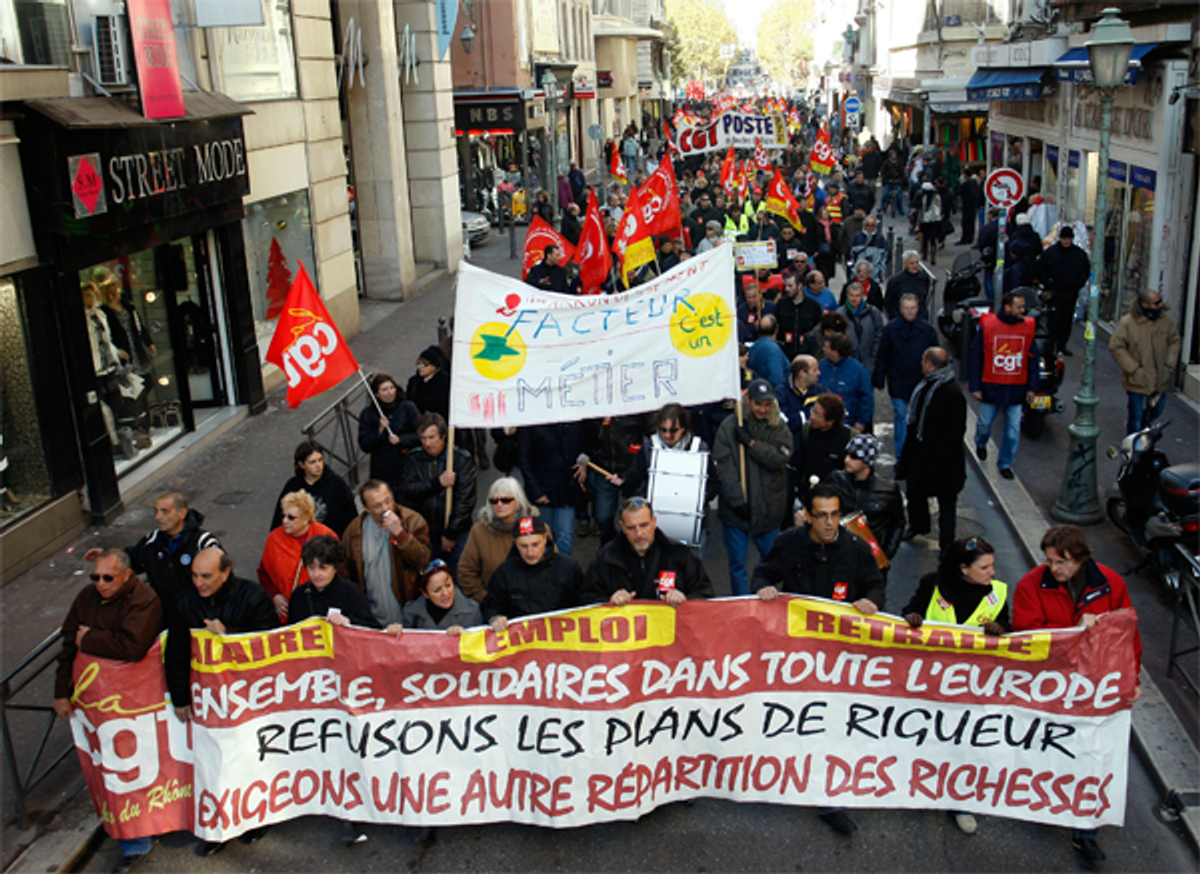 People march to protest a recently-passed pension reform bill in Marseille, France