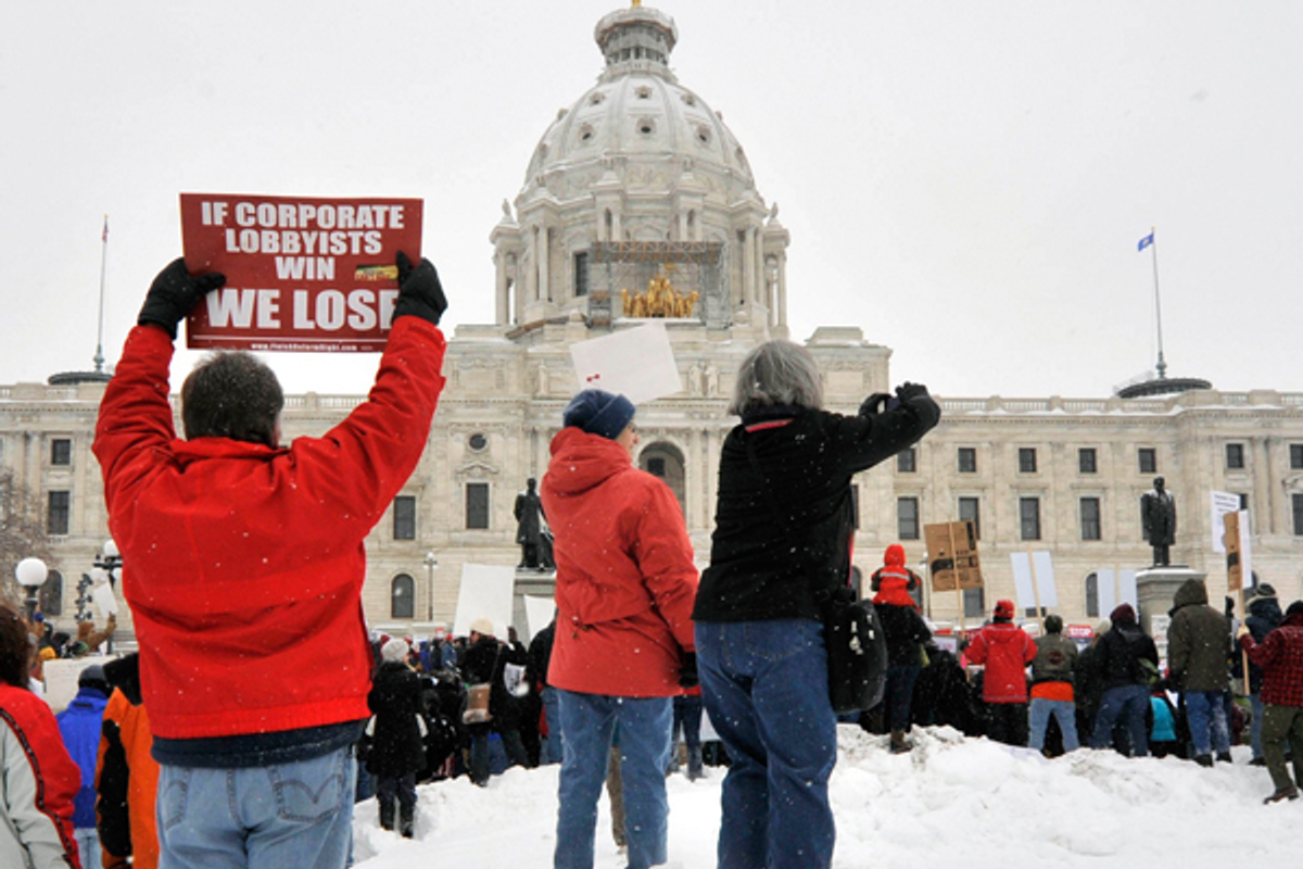 Supporters of workers' rights carry signs in front of the state Capitol in St. Paul, Minn., on Saturday, Feb. 26, 2011 